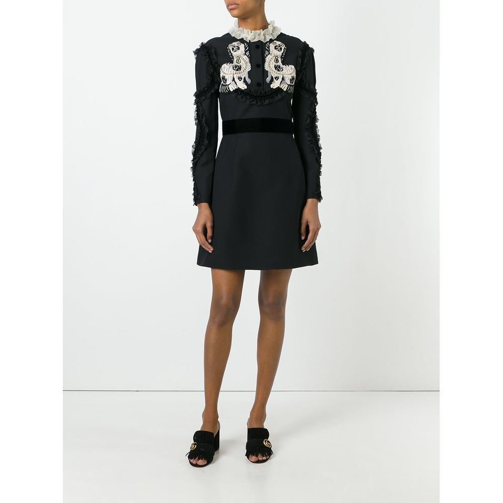 This Gucci dress will infuse your wardrobe with a touch of romanticism. This black wool blend King Spaniel appliqué dress from Gucci features a ruffled neck, a front placket, a concealed rear zip fastening, a concealed rear zip fastening, long
