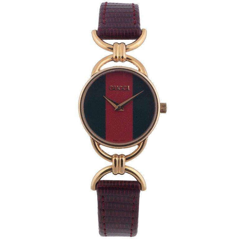 SHIPPING POLICY:
No additional costs will be added to this order.
Shipping costs will be totally covered by the seller (customs duties included). 

A lady's wrist watch. Gold plated case. Signed quartz movement. Green and Red dial. Fitted to a brown