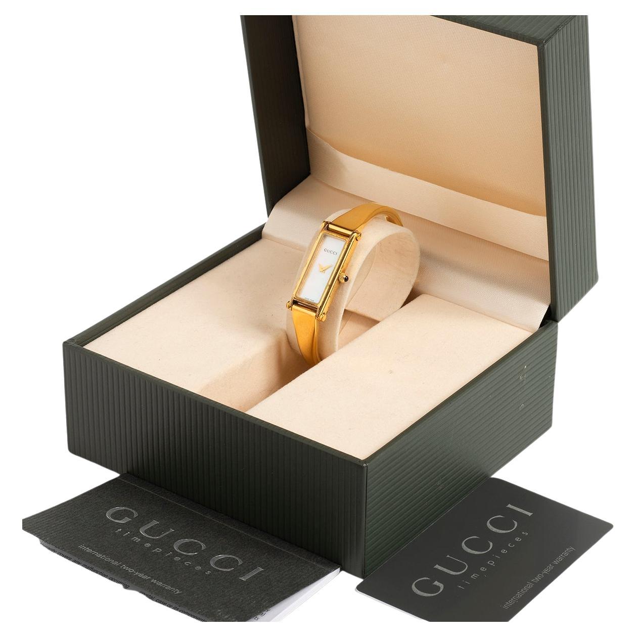 Our iconic neo vintage ladies Gucci, reference 1500L, bangle features the desirable mother of pearl dial with gilt hands and black Gucci logo, heavy gold plated case of 14.7mm (inc crown) x 30mm. The 1500L superseded and replaced the 1500 series and