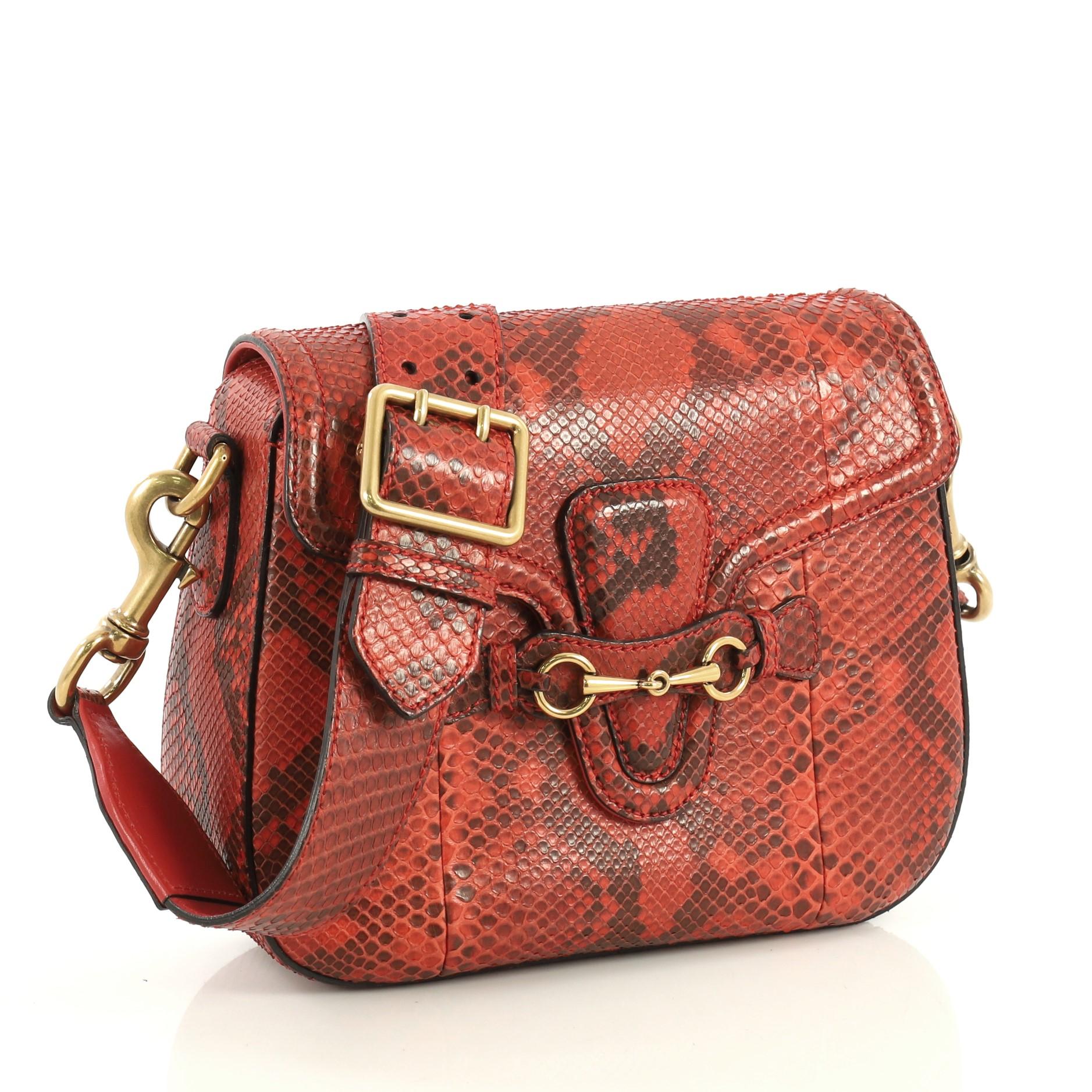 This Gucci Lady Web Shoulder Bag Python Medium, crafted from genuine orange python, features a detachable shoulder strap and aged gold-tone hardware. Its flap closure with horsebit buckle detail opens to an orange leather interior with side zip and