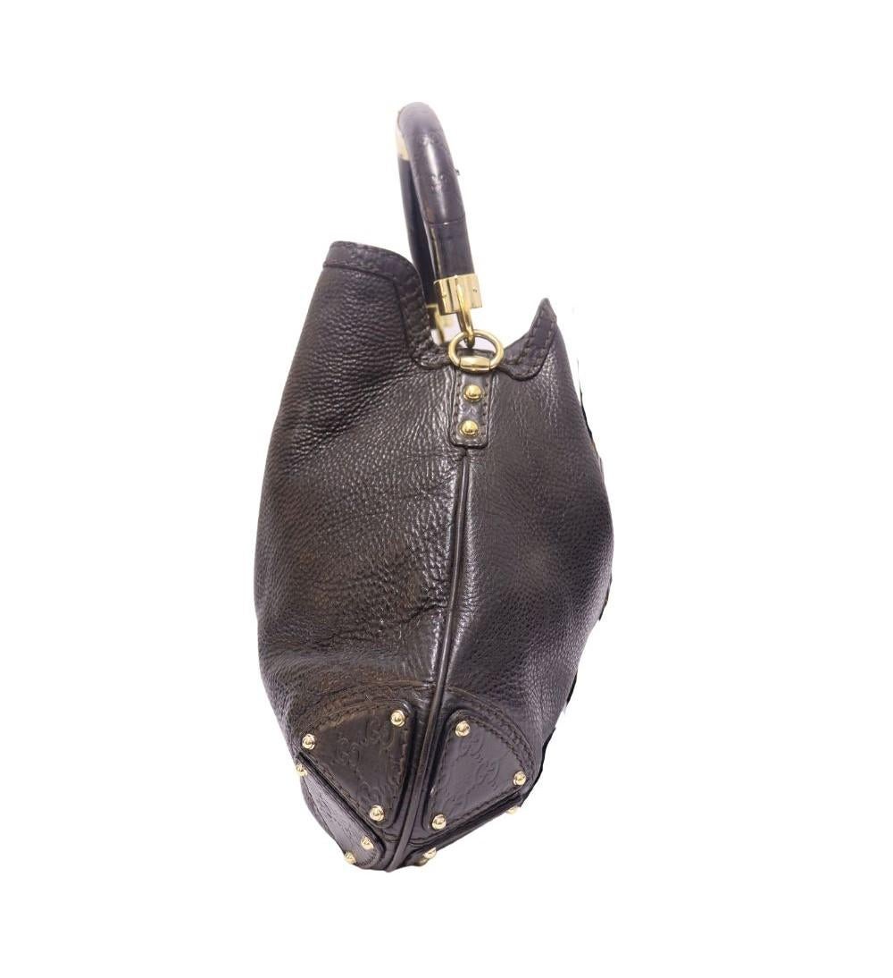 Gucci Large Babouska Indy Hobo, Features Black grained leather, stud embellishments, bamboo-detailed tassels, top closure and one interior zipper pocket.

Material: Leather
Hardware: Gold
Height: 39cm
Width: 48cm
Depth: 2.5cm
Handle Drop: