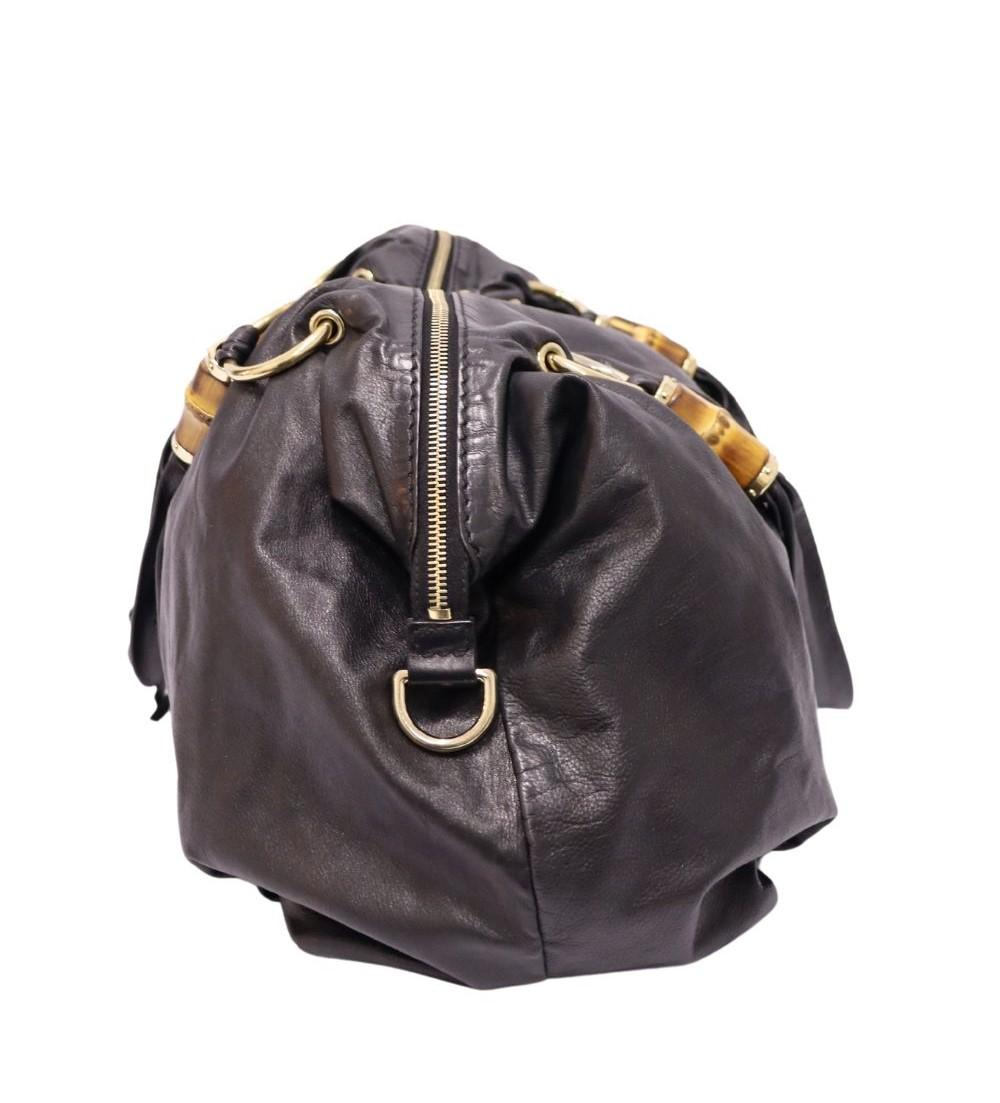 Gucci Large Bamboo Handle Bag, Features a Bamboo Details, Leather Top Handles, Three Interior Pockets, and Top-Zip Fastening.
Material: Leather 

Hardware: Gold
Height: 30cm
Width: 41cm
Depth: 15cm
Shoulder Drop: 23cm
Overall condition: