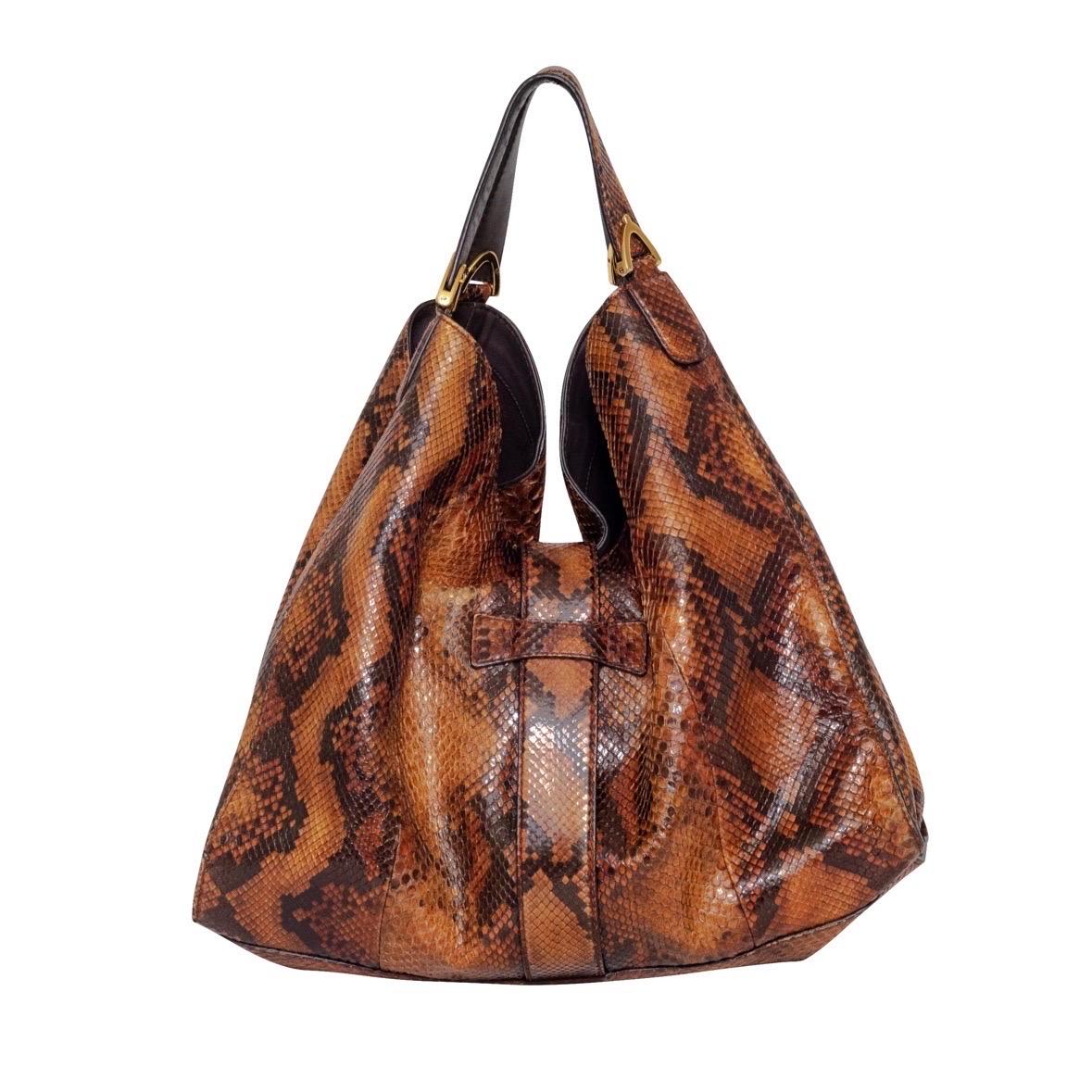 Gucci Large Brown Python Soft Stirrup Bag

Brown
Snakeskin/Python
Gold-tone hardware
Open-top with weighted stirrup strap accent
Top handle; fits on shoulder
Dual strap with stirrup accents on each strap
Brown suede lining with zipper and interior