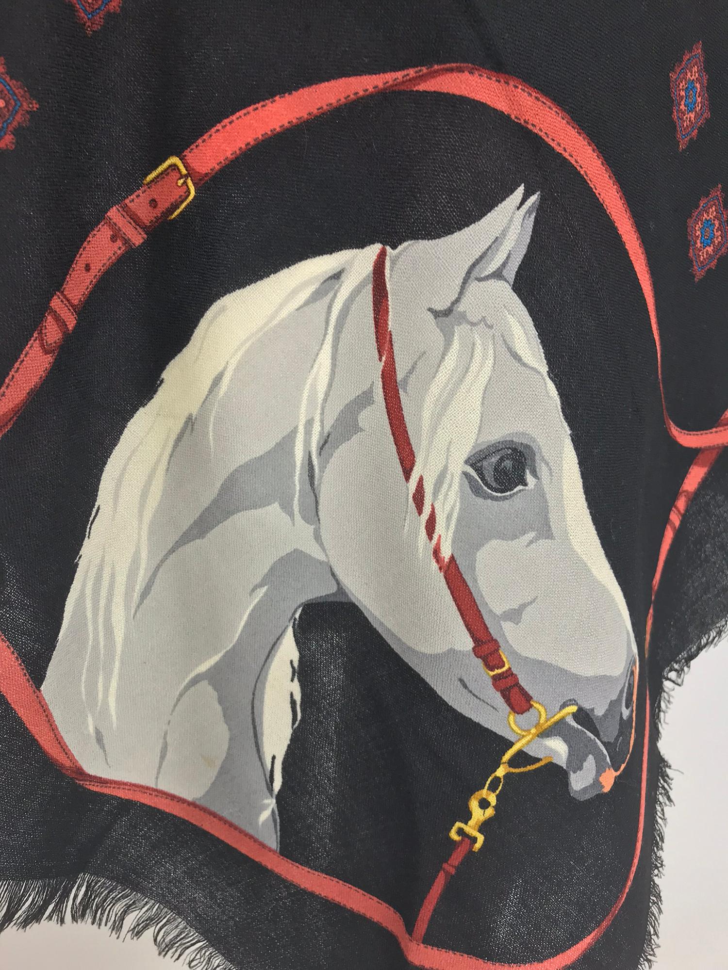 Gucci large horse head wool challis shawl, vintage from the 1990s 1980s.  Black ground with horse in white and grey, bridle and rein design in coral and gold. The center is a pattern of decorative diamond shapes done in blue and coral. The shawl has