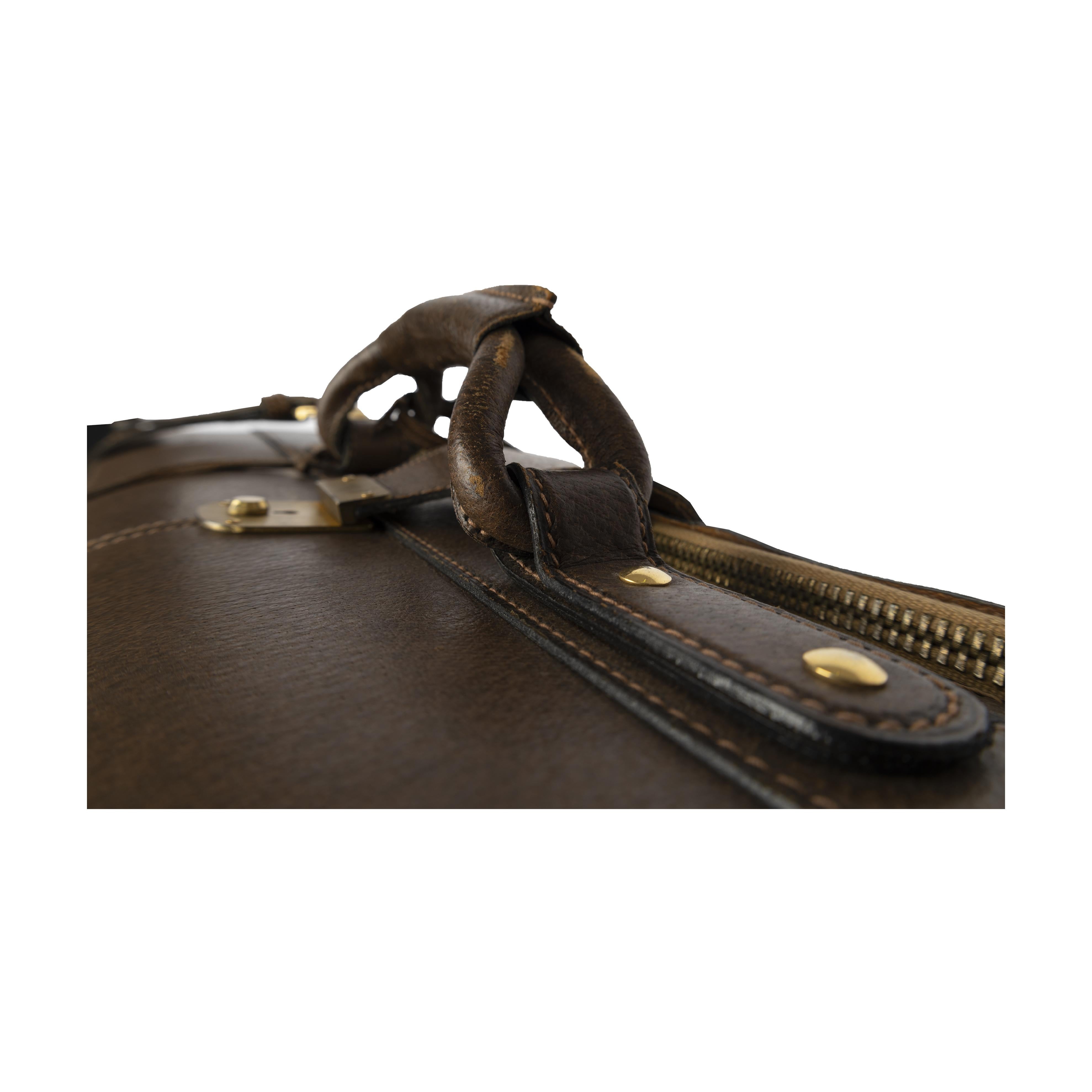 Made in the '70s, this Gucci suitcase is perfect for long stays. With brown suede with the Gucci red and green panels, the handle and area around the main zipper are crafted in leather. It also features an inner pocket to store smaller essentials.