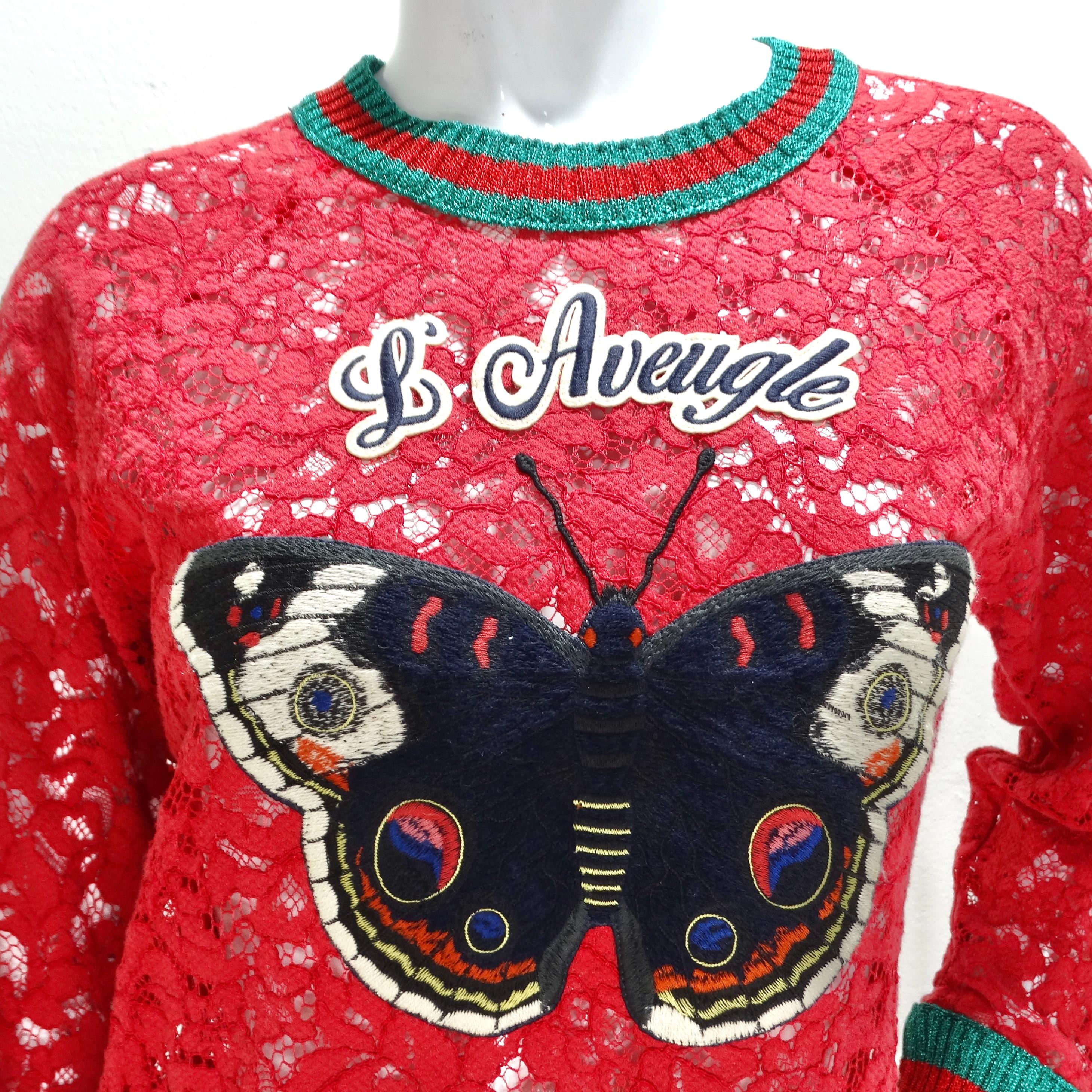 Introducing the Gucci L'Aveugle Par Amour Graphic Print Sweatshirt, a stylish and unique piece that showcases Gucci's signature aesthetic with a contemporary twist. Crafted from red lace, this crewneck sweatshirt features the iconic Gucci red and