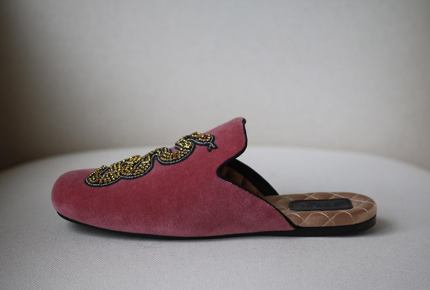 Gucci's footwear gets ever more fantastical for SS17 with the Lawrence slippers rendered in lustrous velvet. Dripping with old world inspiration, the eclectic mix of velvet, silk lining and a highly distinctive embroidered snake anppliqué make the