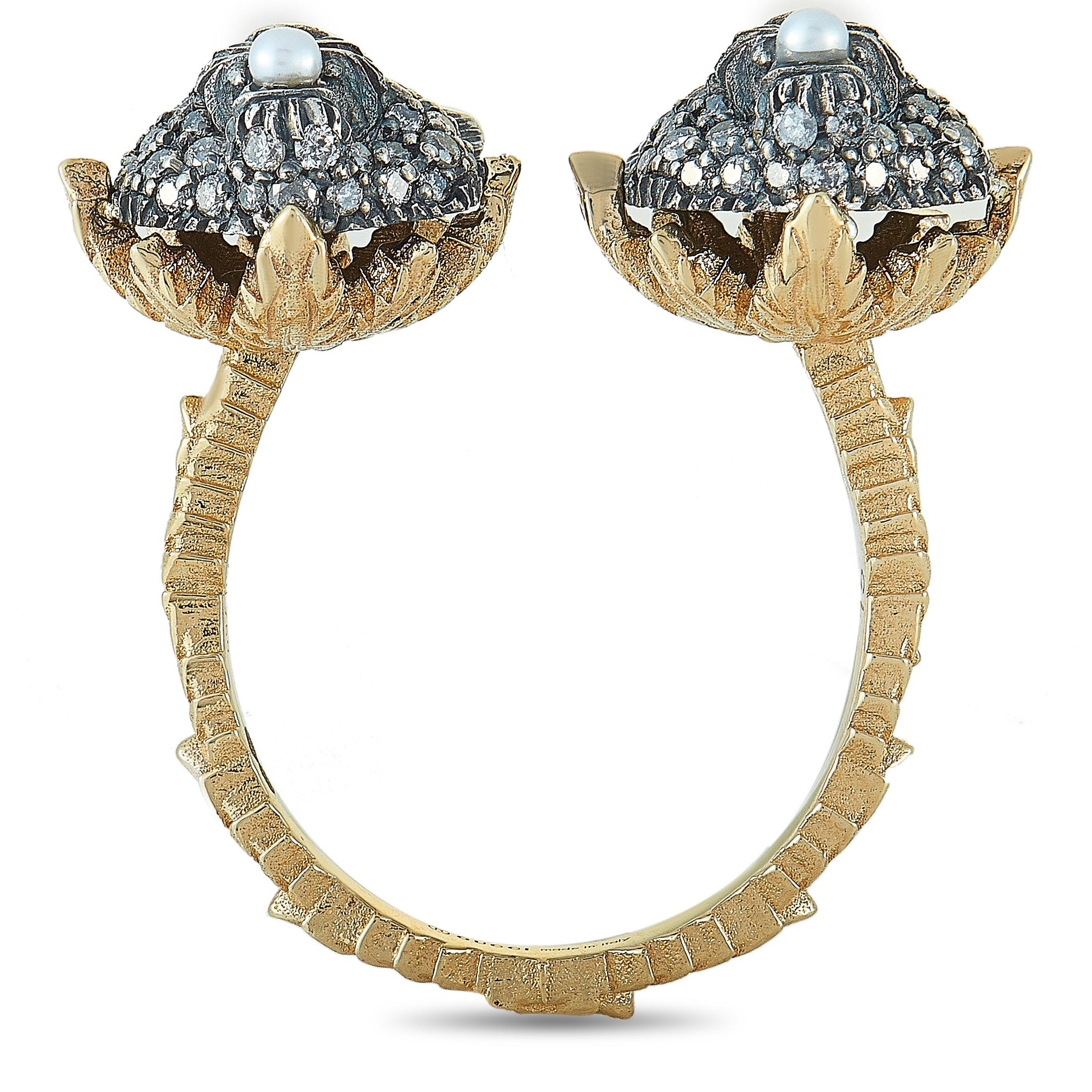 The “Le Marché des Merveilles” ring by Gucci is made out of 18K yellow gold and aged silver and set with white and gray diamonds and two pearls. The gray diamonds amount to approximately 0.62 carats and the white ones feature GH color and VVS
