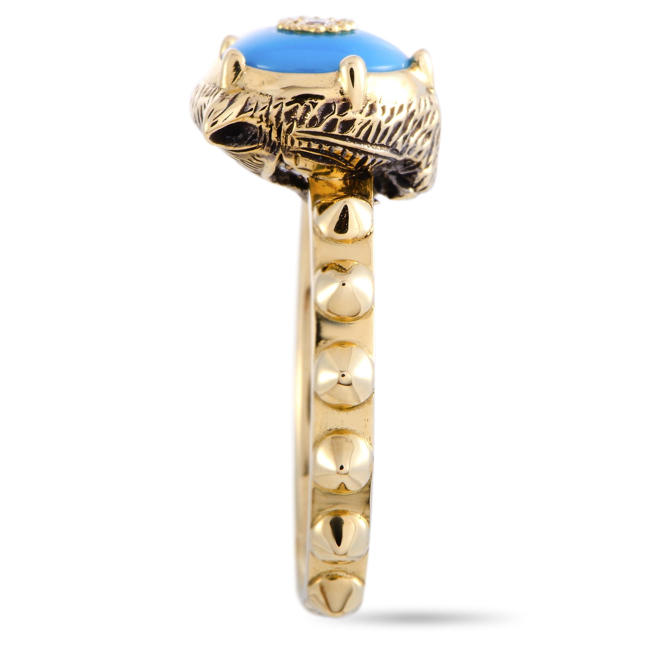 The “Le Marché des Merveilles” ring by Gucci is crafted from 18K yellow gold and set with a turquoise and three diamond stones. The turquoise weighs approximately 1.15 carats and the diamonds boast GH color and VVS clarity and amount to