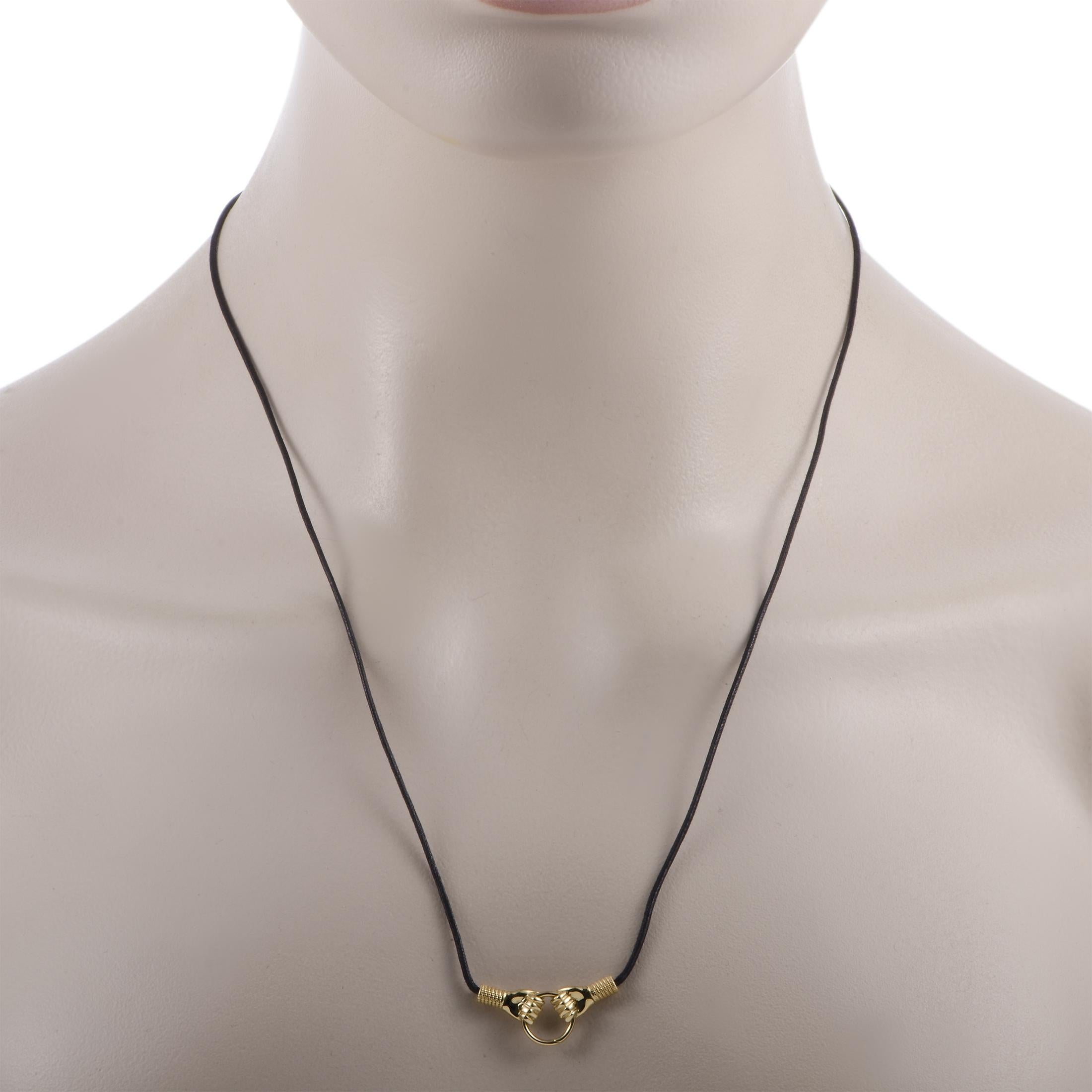 The Gucci “Le Marché des Merveilles” necklace is presented with a 22” black cotton cord and boasts an 18K yellow gold pendant that measures 0.50” in length and 1” in width. The necklace weighs 8 grams.
 
 This jewelry piece is offered in brand new