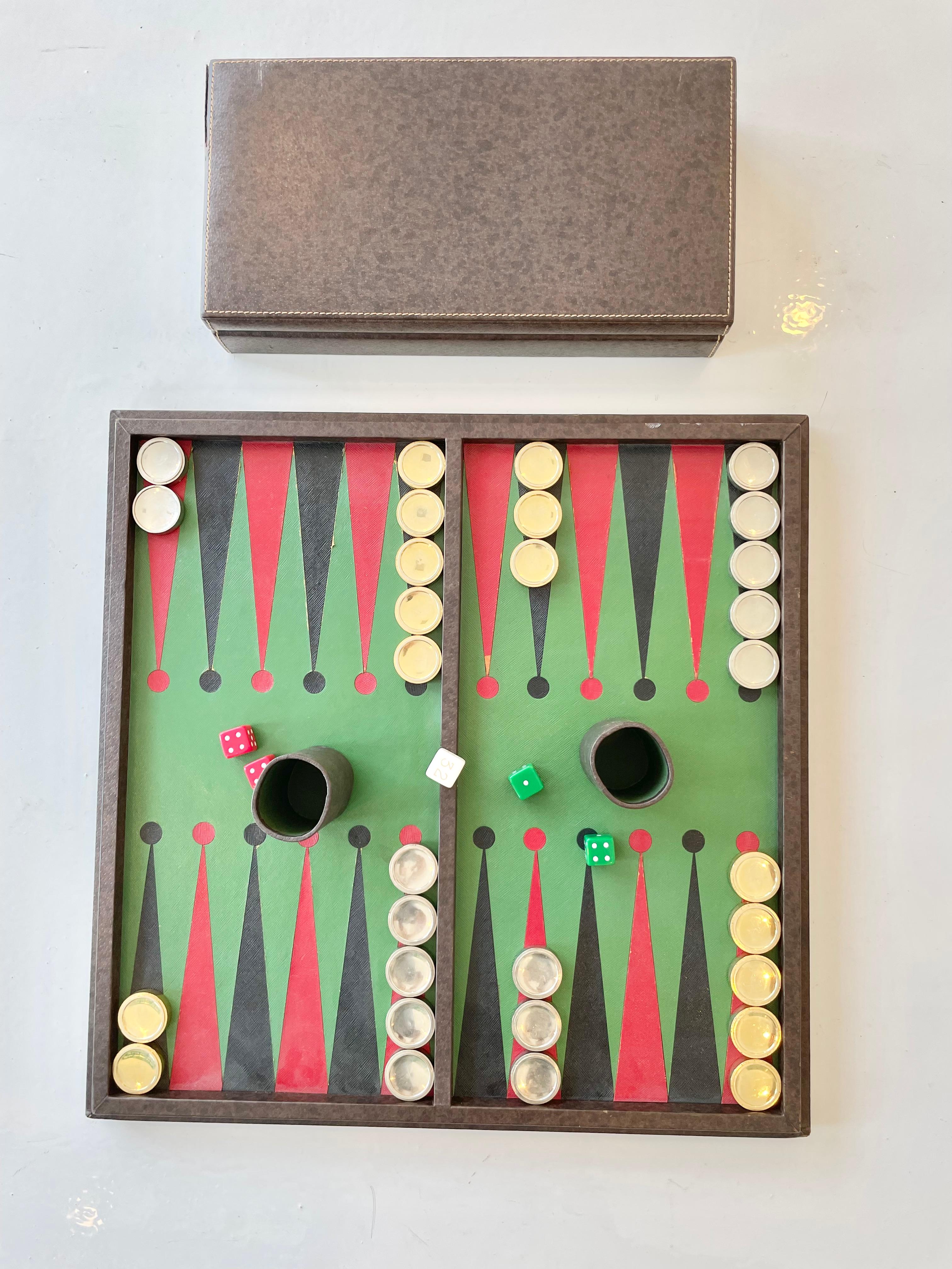 Vintage Gucci game board with backgammon on one side and chess on the other. Sturdy wood framed board wrapped in brown burnished leather with contrast stitching. Traditional green and red Gucci color palette on both game boards with heavy brass and
