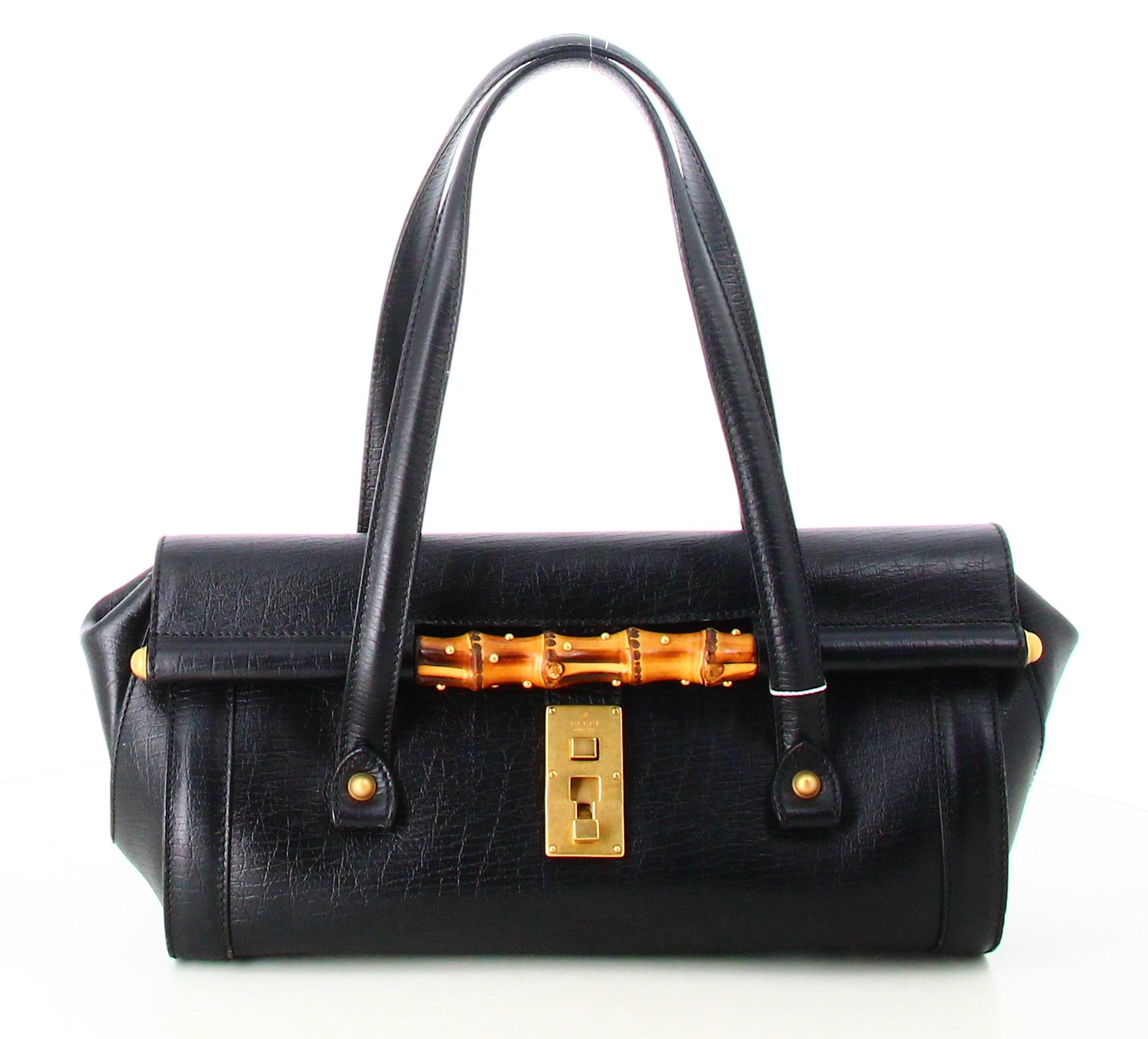 Gucci Leather Bamboo Bullet Shoulder Bag

- Very good condition. Shows very slight signs of wear over time.
- Gucci Bamboo Bag
- Black leather 
- Two black leather straps 
- Clasp: Brown bamboo and golden hook 
- Interior: Black fabric plus inside