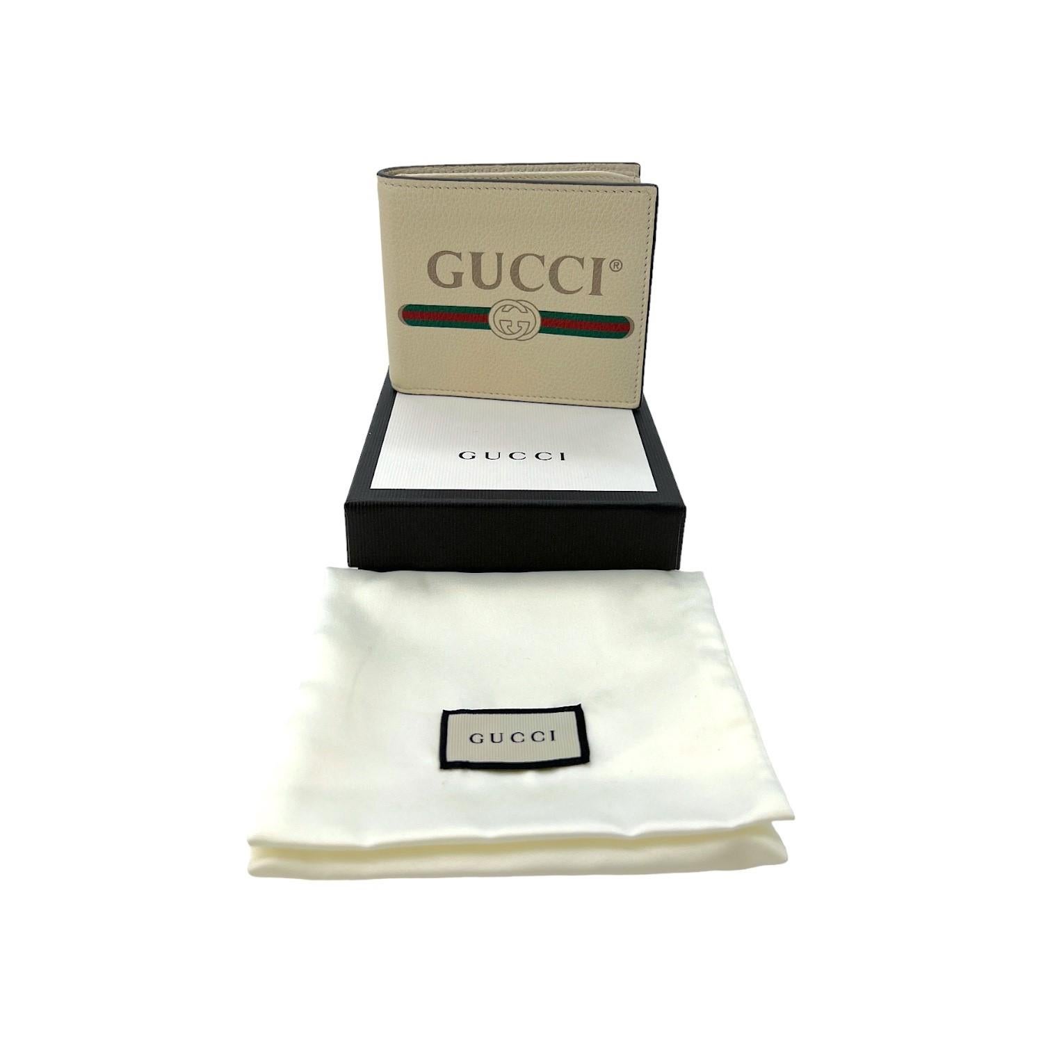 This Gucci Graphic Print Bifold Wallet was made in Italy and it is crafted of cream-colored pebbled leather and it features a Gucci graphic print logo on the front. The bifold wallet opens up to 8 card slots with 2 coin pockets and 2 bill