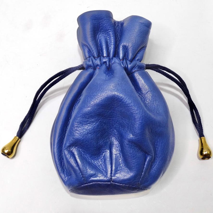 Get your hands on this vibrant vintage Gucci jewelry pouch circa 1970! A beautiful electric blue leather is complimented with a bright red interior and a navy drawstring chord with gold tone accents. Un-cinch the chord to reveal a red interior ideal