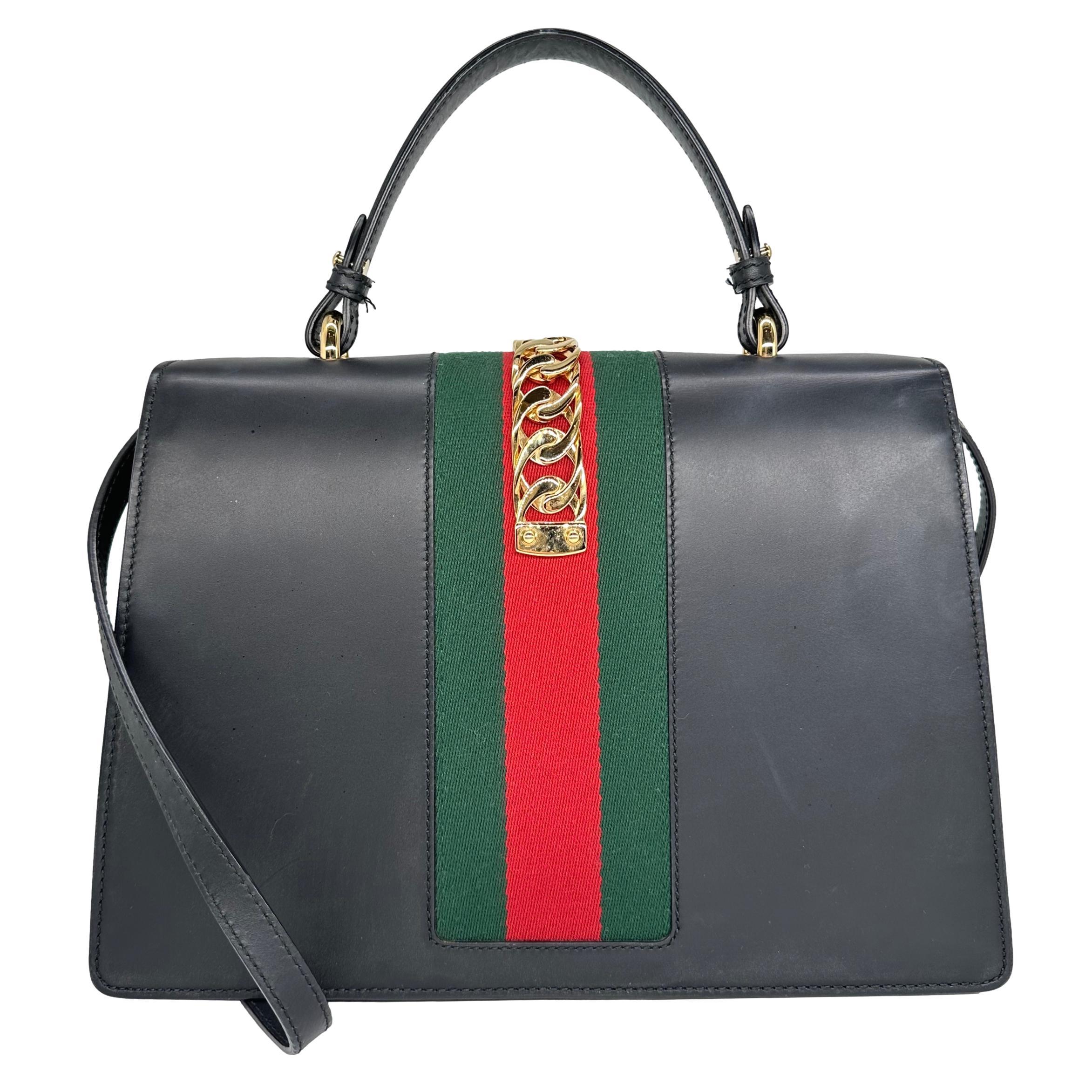 Gucci Leather Medium Sylvie Web Chain Belt Lock Top Handle Crossbody Bag, 2018. As seen in the 2018 Mother's Day Gucci Campaign starring actress Faye Dunaway and musician Soko, the 1960's Sylvie is reimagined by the iconic fashion house in an array