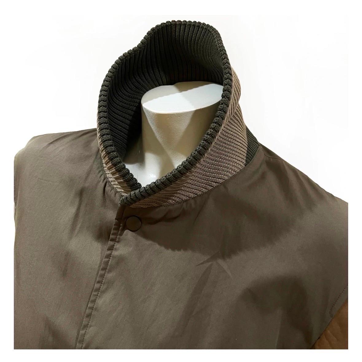 Leather Sleeve Bomber Jacket by Gucci
Fall 2010 Menswear Collection
Made in Italy
Olive green
Brown leather sleeves
Front snap button closure
Long sleeves
Ribbed striped cotton trim detail
Dual open side pockets
Interior pocket with zip closure