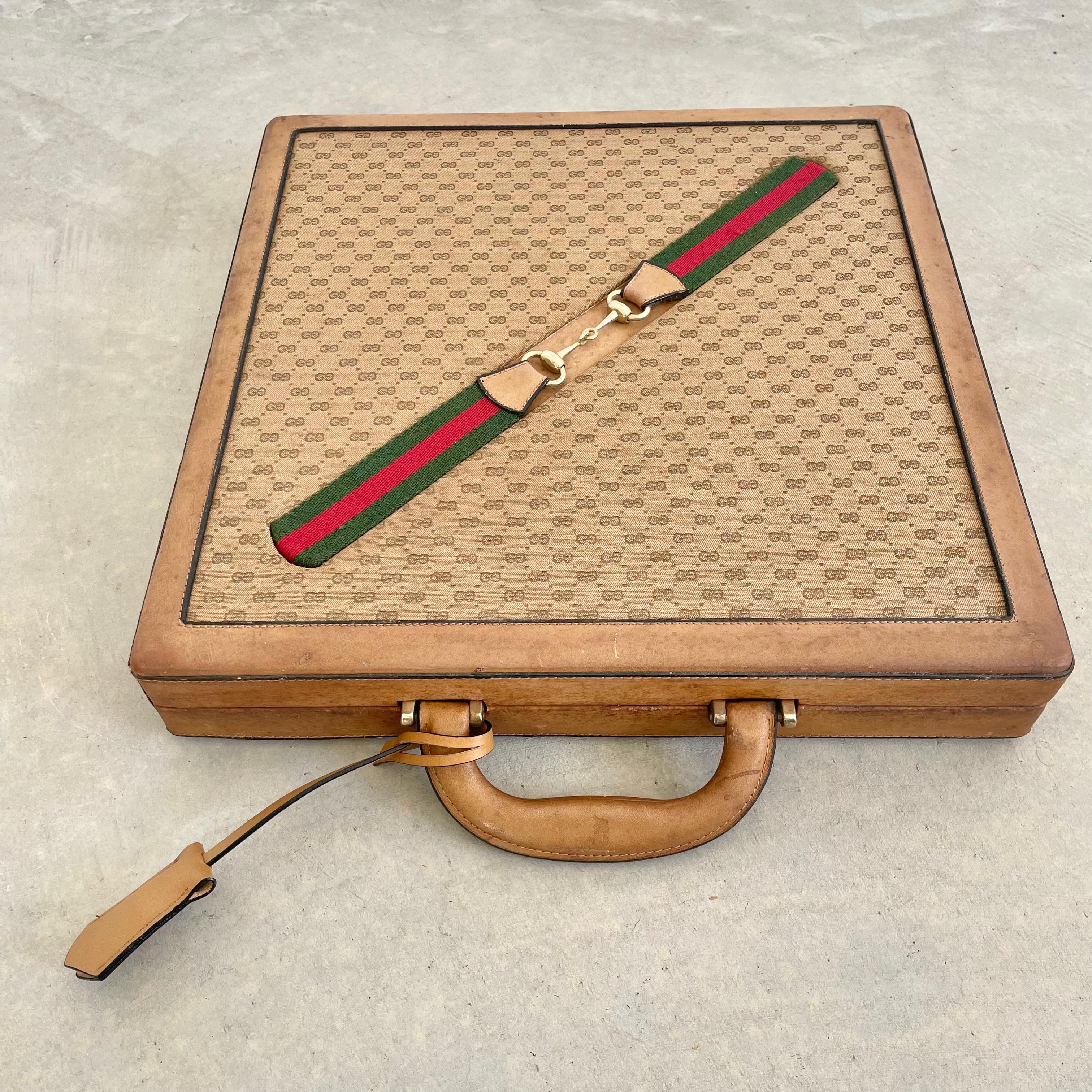Vintage portable Gucci leather game case with chess, checkers and backgammon. Wood framed case wrapped in an elegant canvas with leather accents. Canvas features a repeating sequence of the Gucci interlocking 