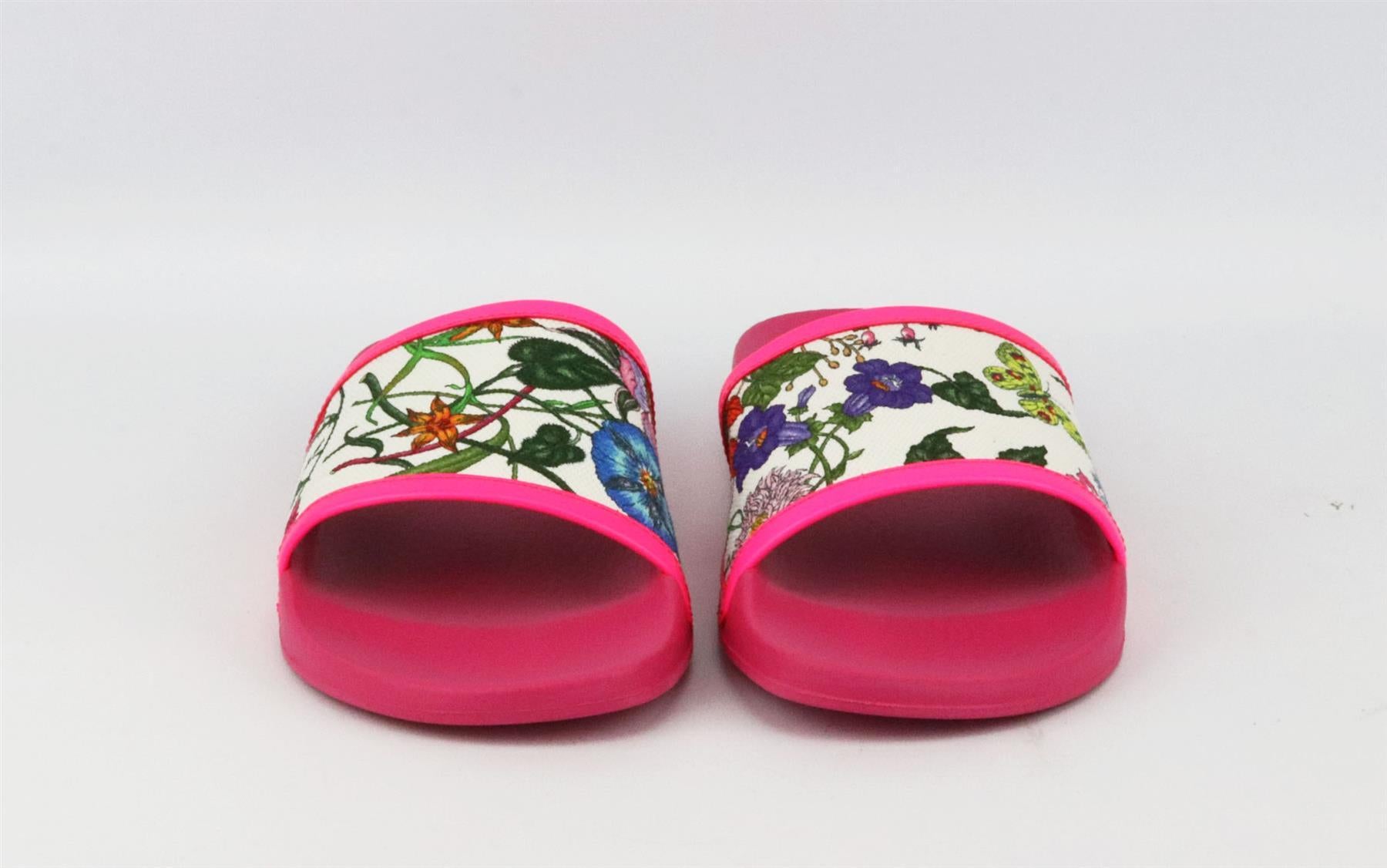 These slides by Gucci are made in Italy from canvas decorated with fresh flowers in bloom, they're trimmed with neon-pink leather and pink rubber. Sole measures approximately 20mm/ 1 inches. Pink leather, multi-coloured canvas, pink rubber. Slips