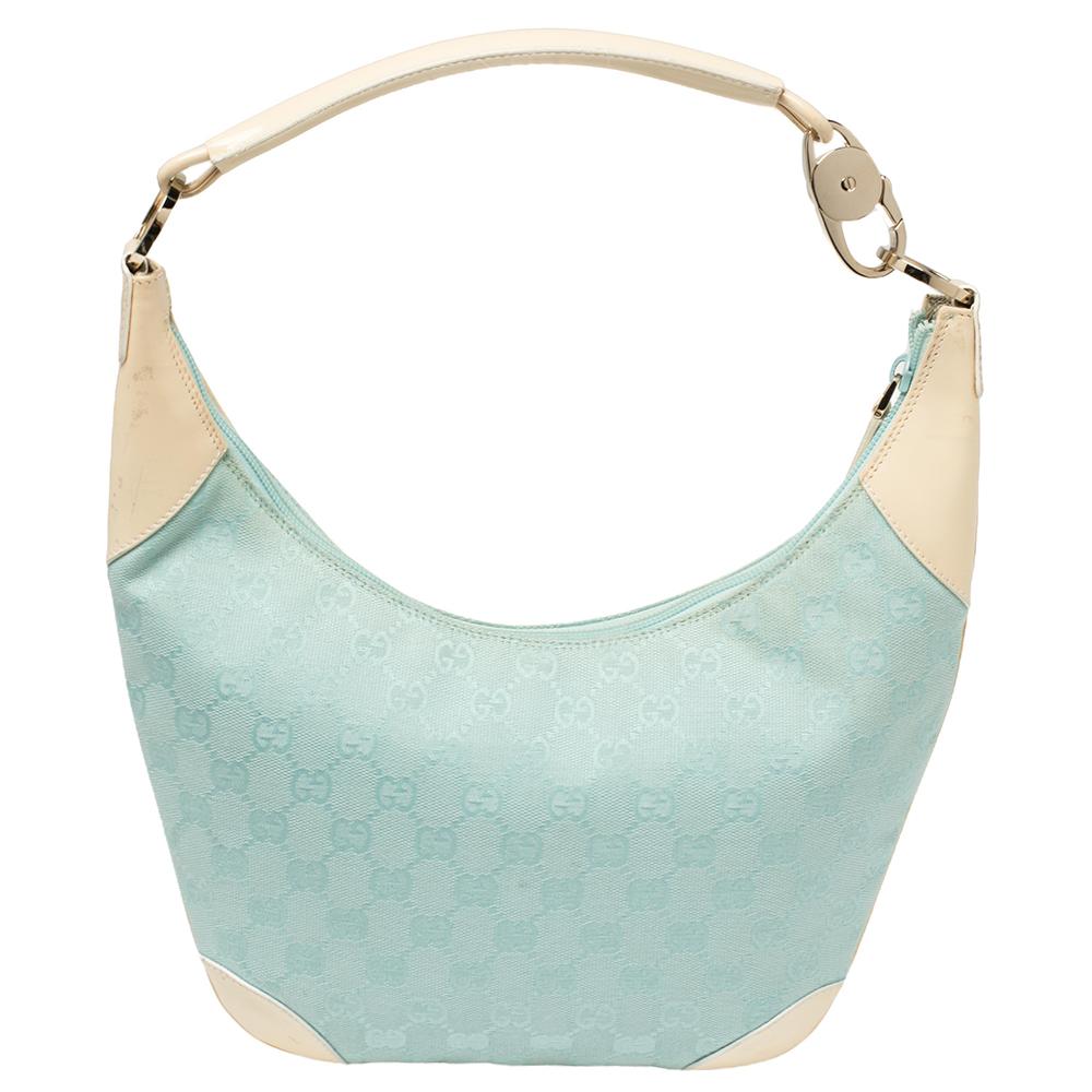 This Gucci hobo for women comes fashioned with light blue GG canvas and cream patent leather. It has a convenient size and a signature Gucci appeal that's luxurious. The designer hobo bag is lined with fabric and held by a single handle.

