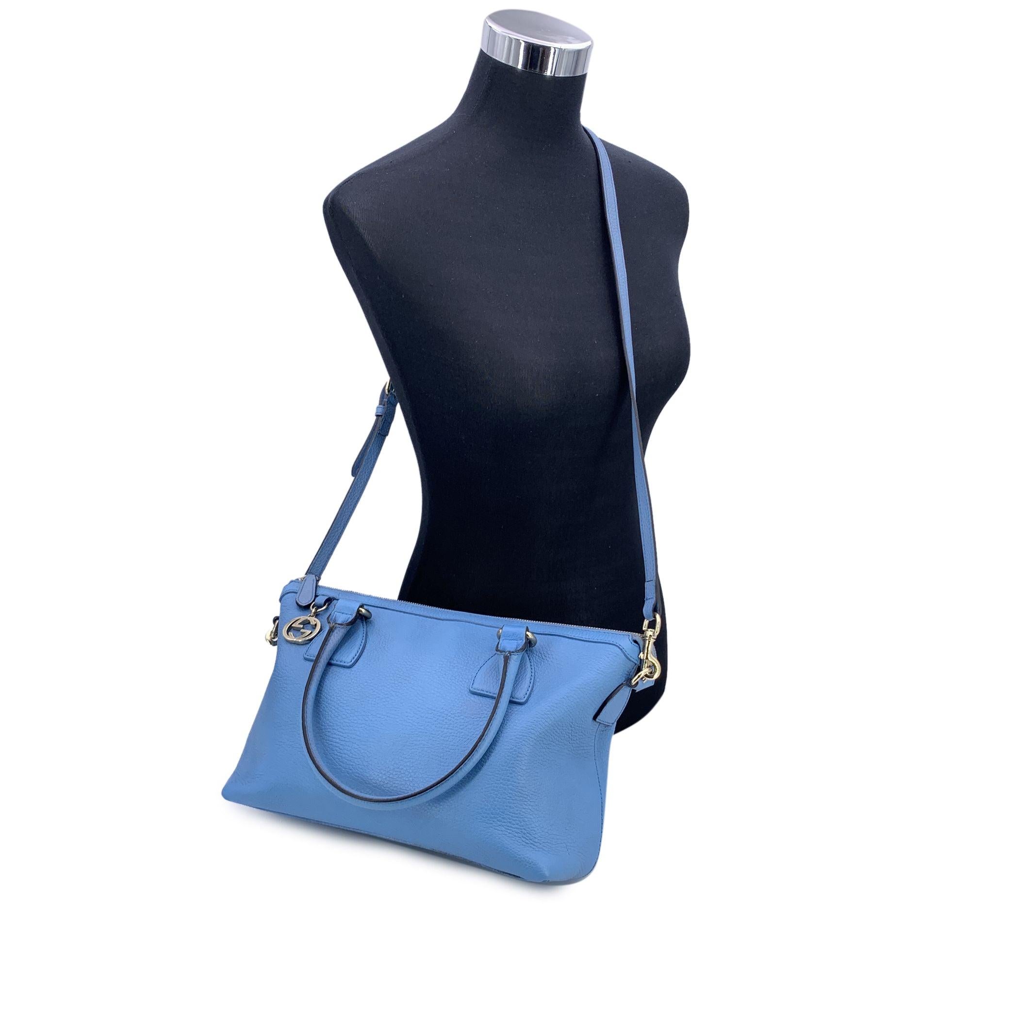 Introducing the authentic Gucci GG Charm Satchel in light blue Dollar calfskin leather - a timeless piece that effortlessly combines sophistication with practicality. Crafted from luxurious grained leather in bright lght blue hue, this chic tote
