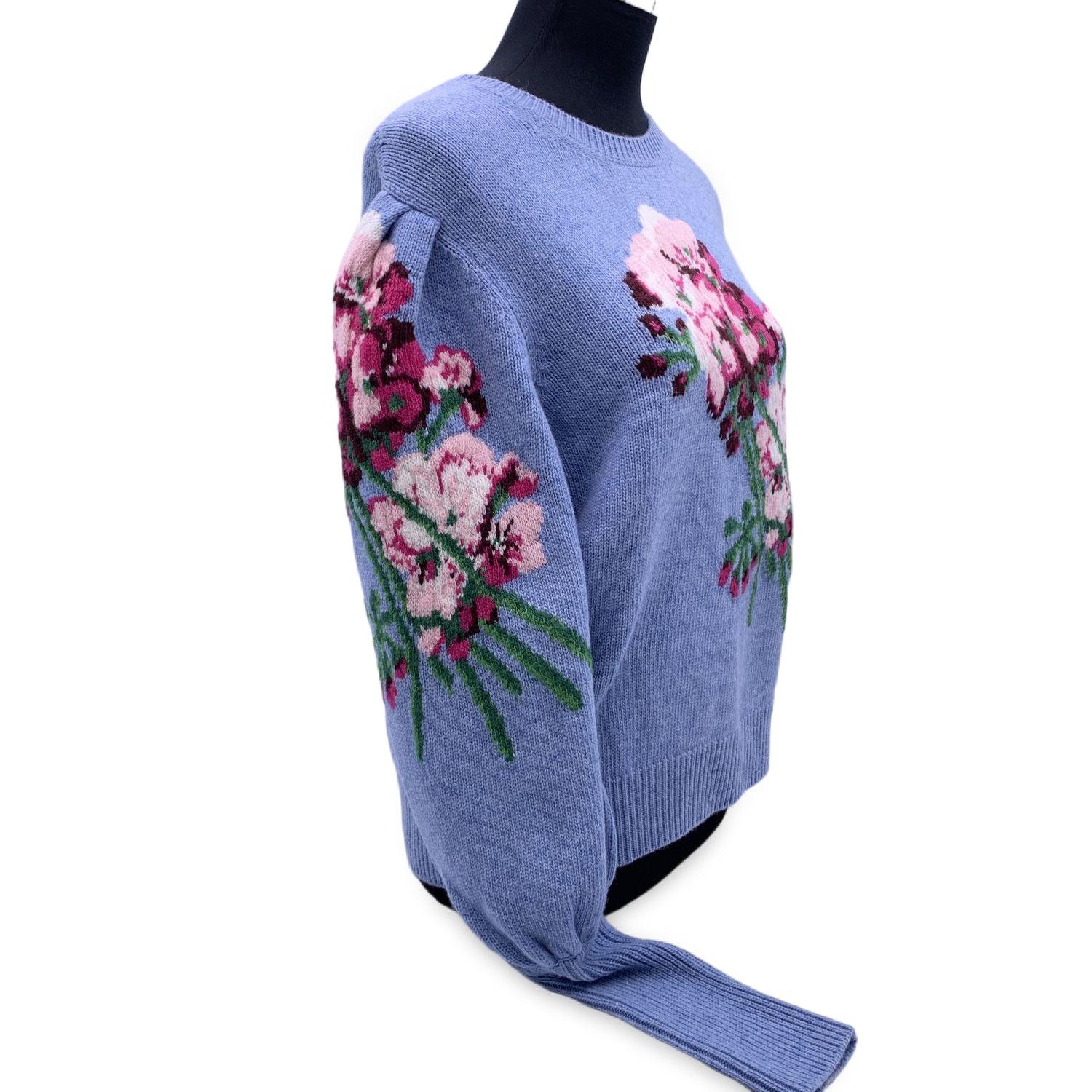 Gucci light blue wool Intarsia Flowers Sweater from the 2021 collection. Inspired by botanical prints. Crafted from merino wool with flowers intarsia. It features crewneck, ribbed neck, cuffs and hem. Puffed sleeves. Size L. Made in Italy. Retail