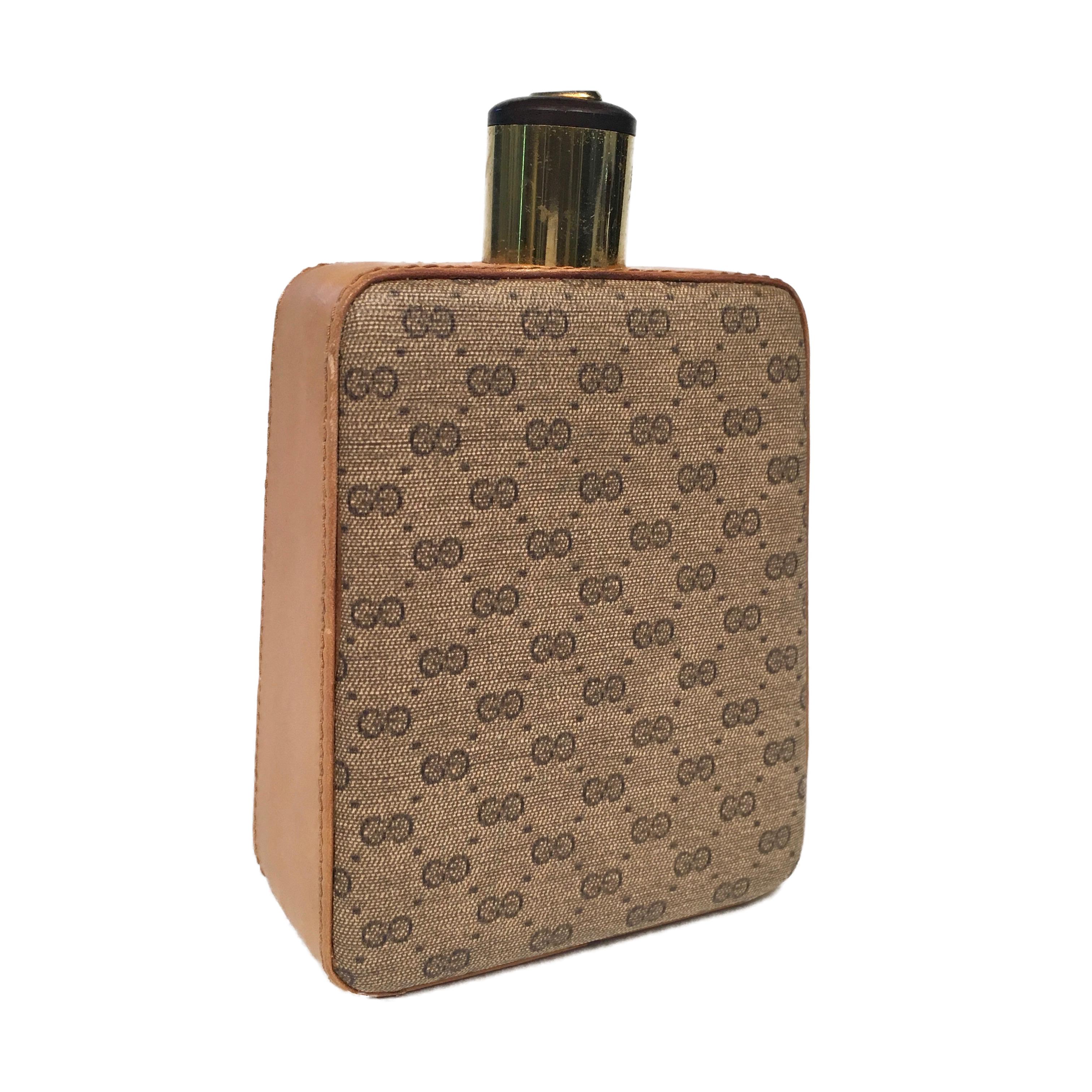 This ultra rare flask was made by Gucci, most likely in the early 1970s. Made from brown leather, it features Gucci's iconic webbing embroidered.
Stamped Gucci MADE IN ITALY.