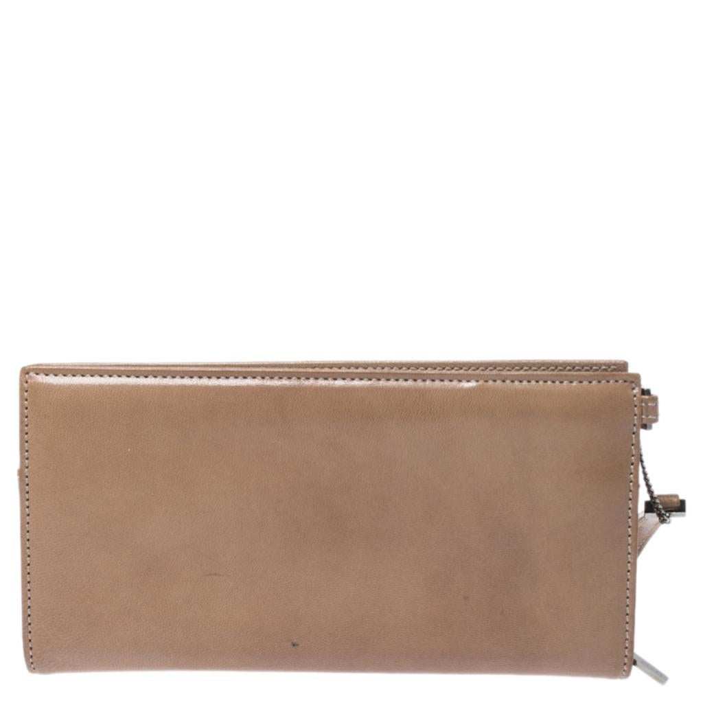 Give your essentials a stylish home with this wallet from the house of Gucci. Made from quality leather, this wallet is a long-lasting accessory. The light brown hue, the wristlet and the well-equipped interior make it a worthy purchase.

Includes:
