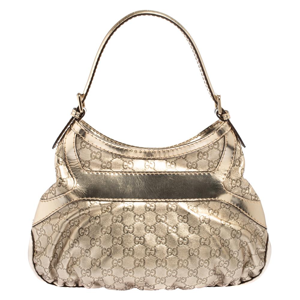 Crafted from Guccissima leather, this hobo from Gucci is designed with great attention to craftsmanship. It has a stunning light gold color that adds a touch of glamour. The bag's spacious interior is lined with fabric and secured well, and a single