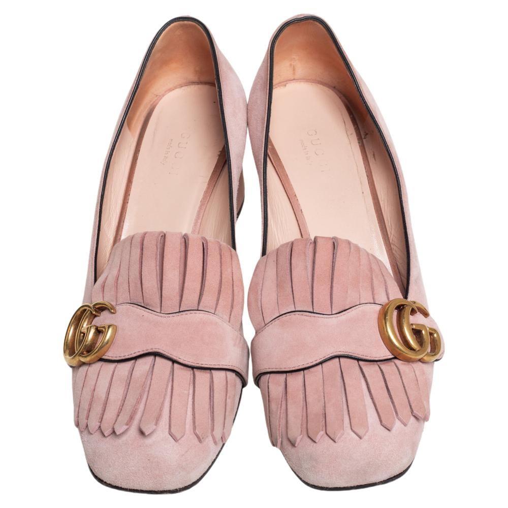 This pair of pumps by Gucci is a buy to wear and treasure. They've been crafted from light pink suede and styled with folded fringes with the brand's signature GG on the uppers. Square toes and a set of block heels complete the pair.

Includes: