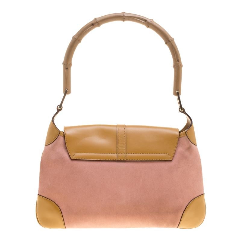 This stunning bamboo shoulder bag handcrafted in Italy will make a standout addition to your collection. The gorgeous bag is crafted from leather and suede and is accented with a bamboo handle. The nylon lined interior is spacious and will