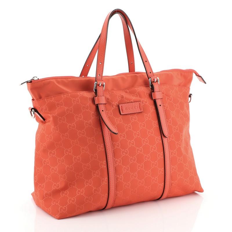 This Gucci Light Tote Guccissima Nylon Medium, crafted in red guccissima nylon, features dual slim handles and silver-tone hardware. Its zip closure opens to a red nylon interior with side zip and slip pockets. 

Estimated Retail Price: