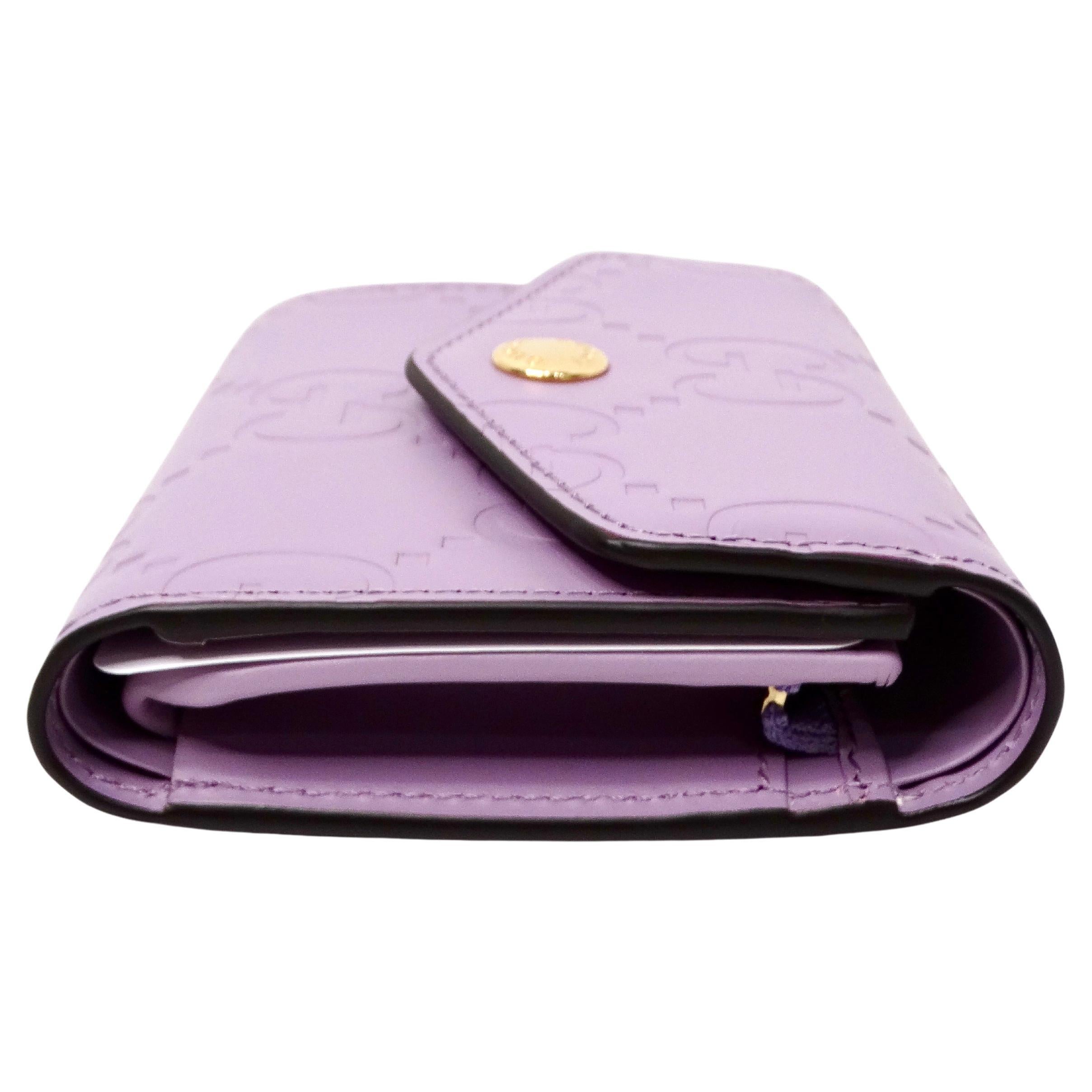 The Gucci Lilac GG Embossed Leather Tri-Fold Square Wallet is a luxurious accessory that combines elegance with practicality. Crafted from high-quality embossed leather, this wallet features the iconic Gucci GG pattern in a soft, sophisticated lilac