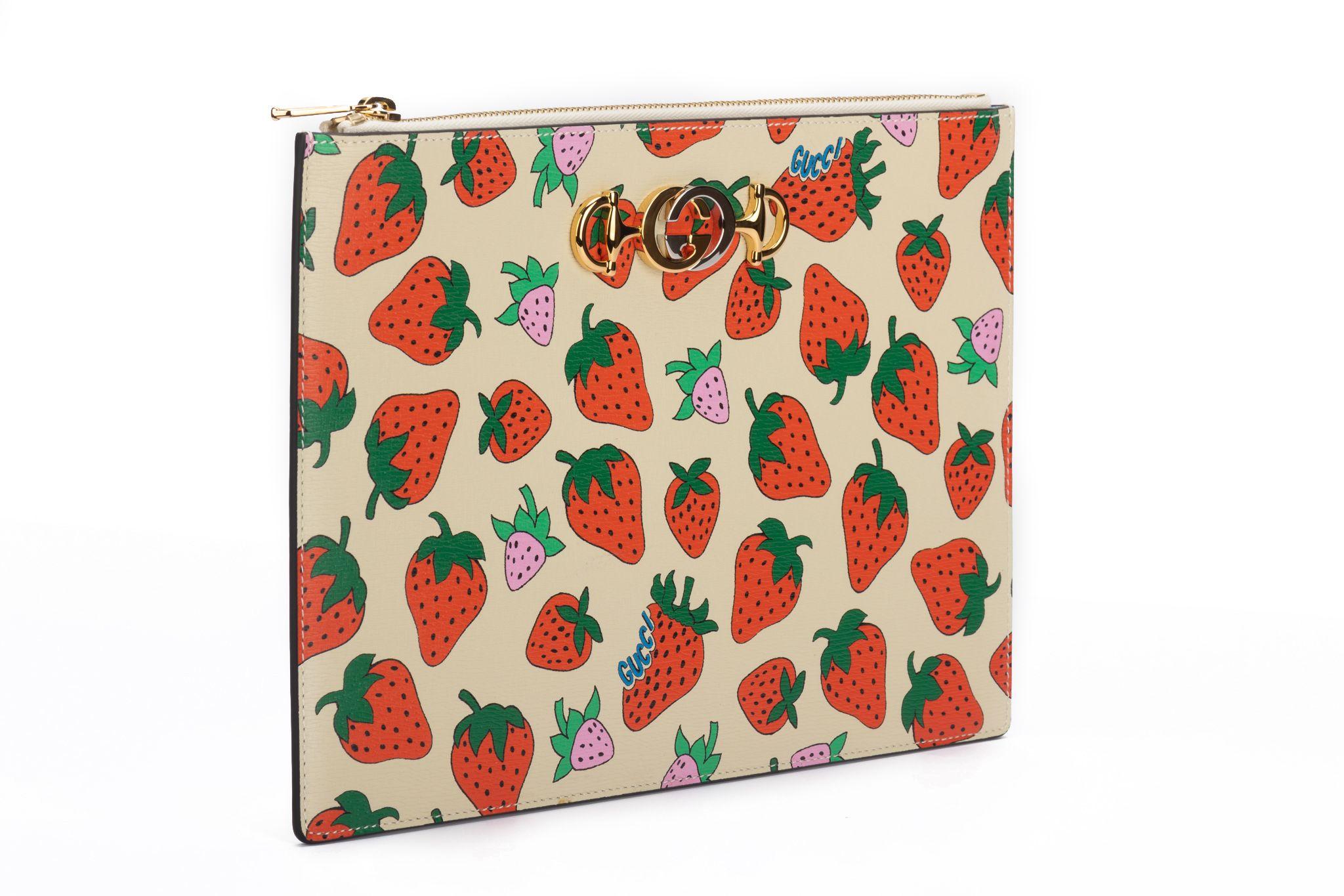 Gucci NIB limited edition strawberry clutch. Cream leather, two tone hardware. Comes with booklet, original dust cover and box.