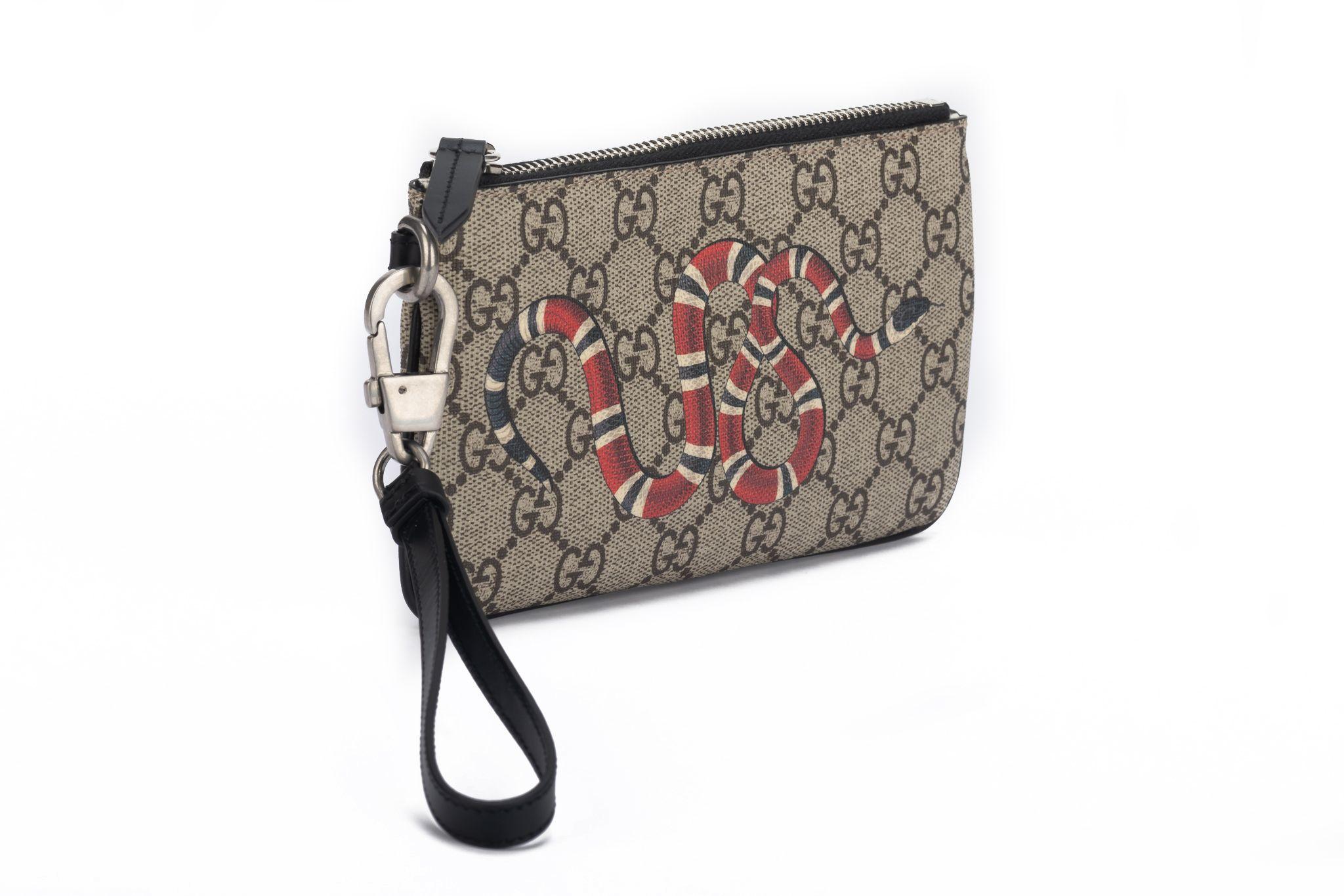Gucci new brown coated monogram canvas wristlet with painted snake design, limited edition . Detachable handle. Comes with dust cover and original box.
