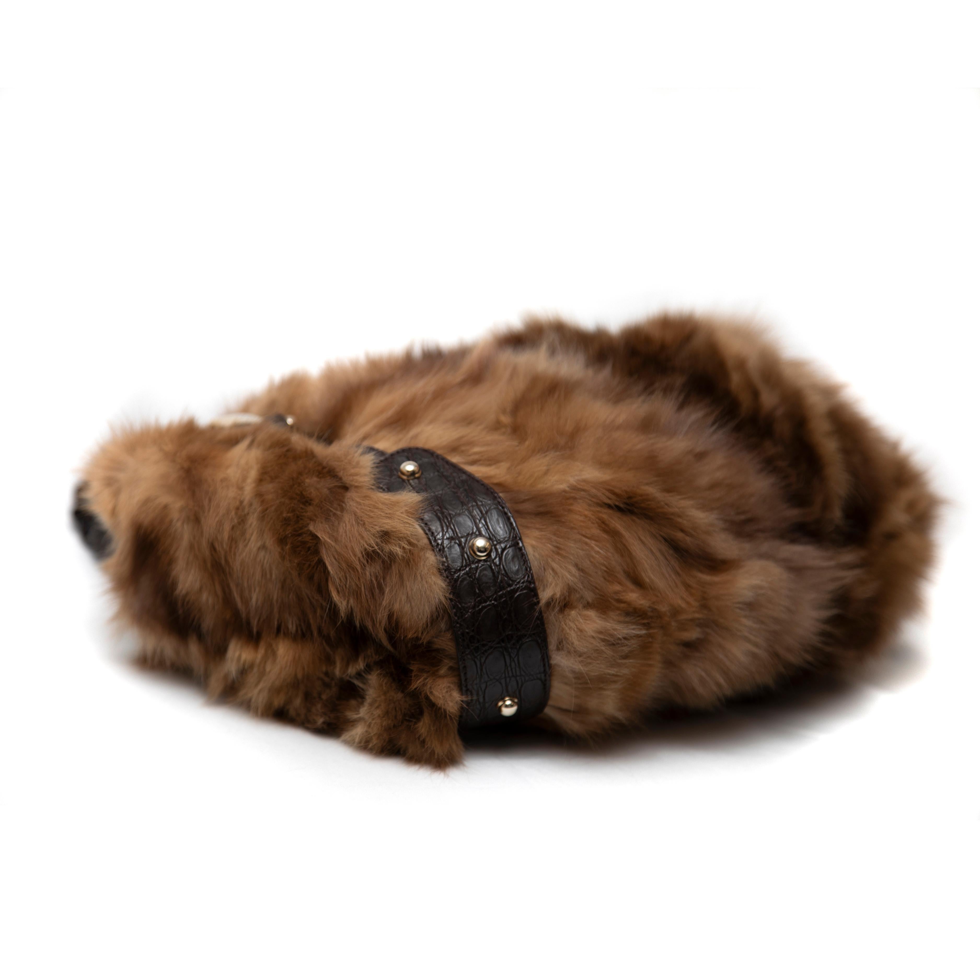Celebrate luxury and exclusivity with the Gucci Limited Edition 85th Anniversary Mink Fur Hobo Bag from the Fall 2006 collection. This eye-catching piece is crafted from plush rmink, offering an incredibly soft texture that embodies high fashion and