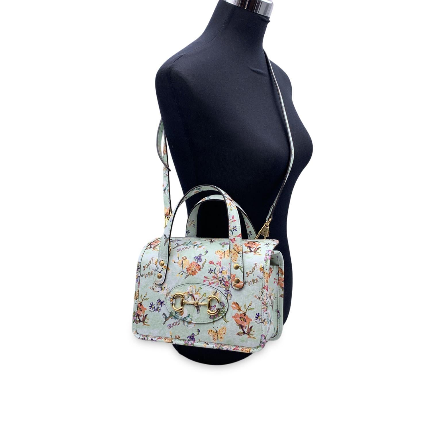 SStunning 'Horsebit 1955' top handles bag by Gucci, from the 2021 Love Parade collection. This is a limited edition (numbered tag inside). Aqua green/mint leather with floral print. Structured design. Gold metal horsebit on the front. Double handles