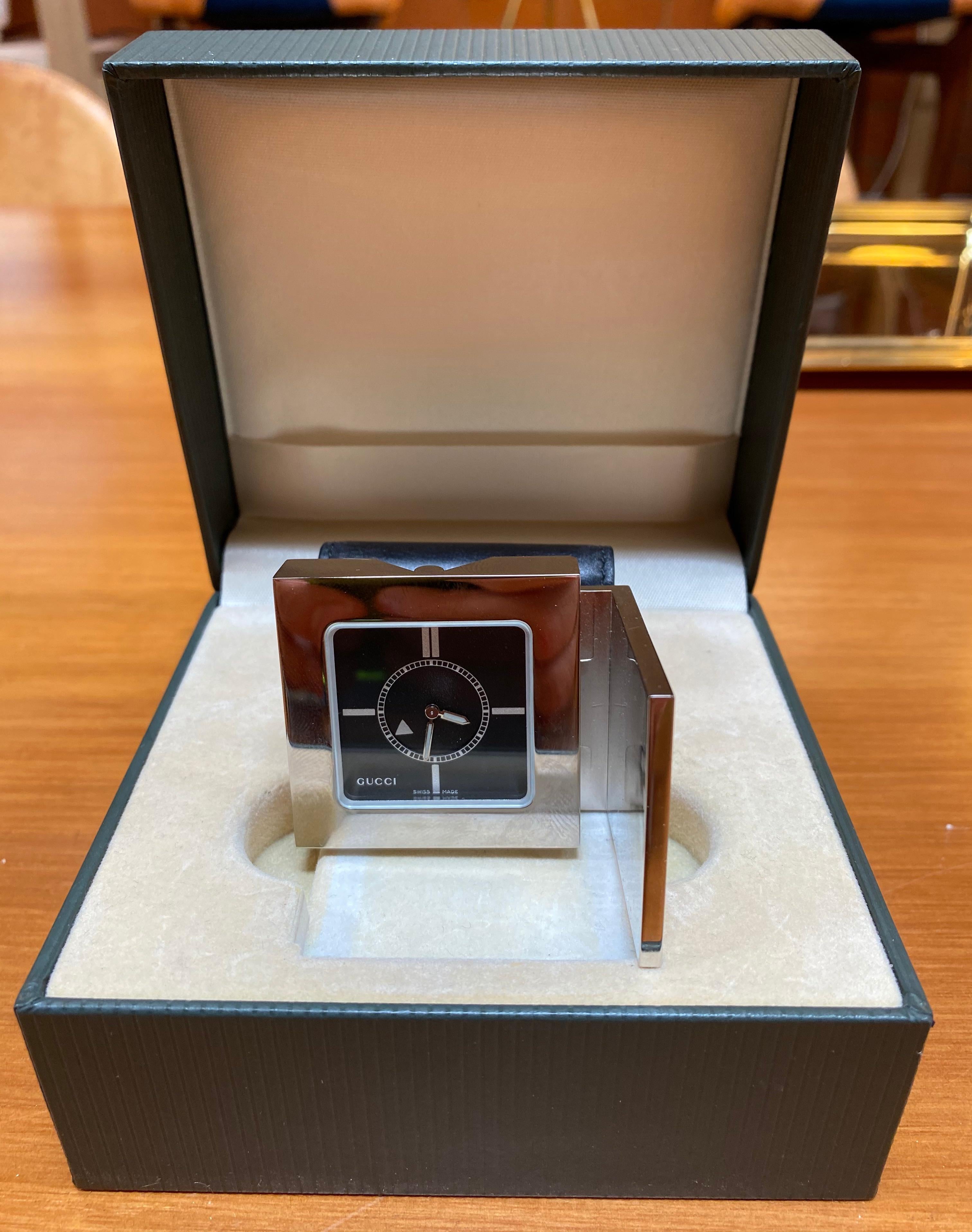 Rare authentic Gucci deluxe chrome cased pocket size, alarm travel clock watch that folds out to stand. Alarm indication on rotation, number 3895 engraved on back, model 0895, Swiss made quartz movement. Comes in soft leather calfskin pouch with