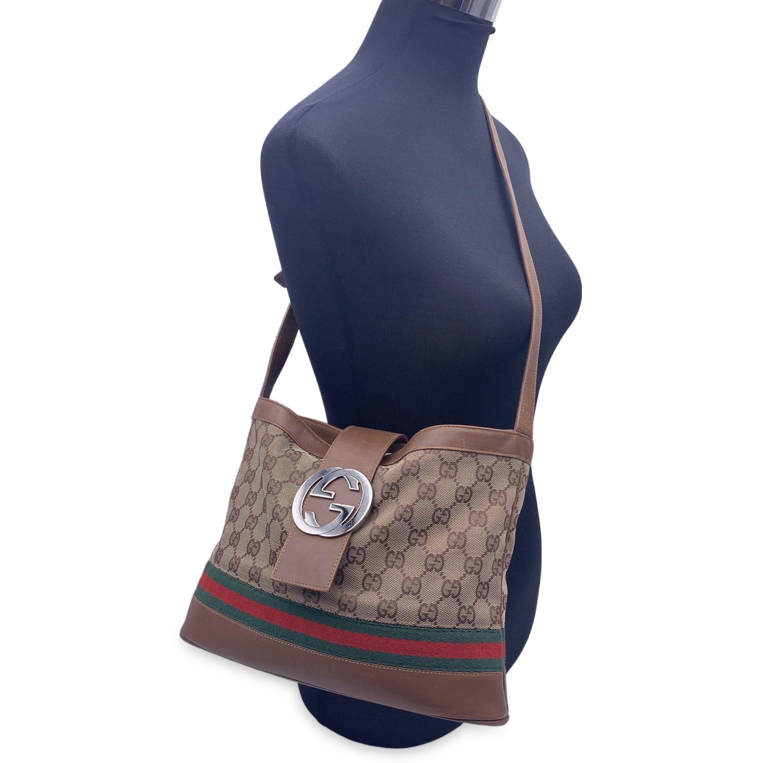 Limited edition Gucci 'GG Sherry Line' shoulder bag crafted in beige monogram canvas with light brown leather trim. Green/Red/Green stripes on the lower part of the bag. Fold-over strap with silver metal GG - GUCCI logo on the front. 'Gucci