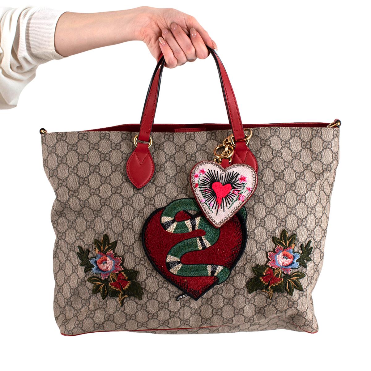 Gucci Limited Edition Red & Brown GG Monogram Canvas Shopper Bag

- Made of the iconic GG monogram canvas 
- Contrasting soft leather trims 
- Gold tone hardware 
- Detachable shoulder strap 
- Heart shaped bag charm
- Embroidered patches 
-