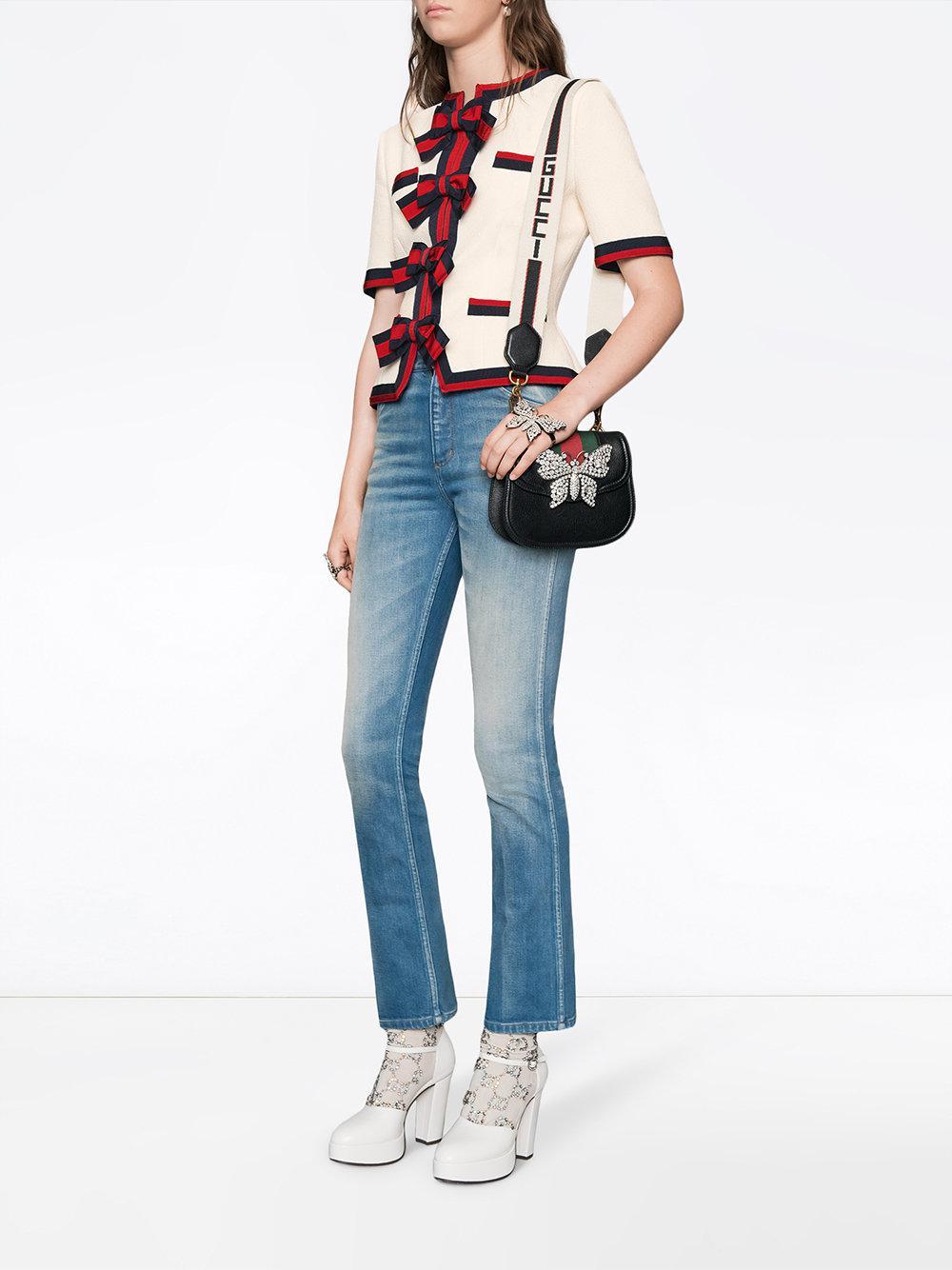 Gucci Linea Totem Small Crystal Rhinestone Crossbody Bag.  Small black leather bag with signature red and green web stripe.  Canvas web Gucci logo removable shoulder strap, magnetic clasp closure, suede lined interior, clear rhinestone crystal