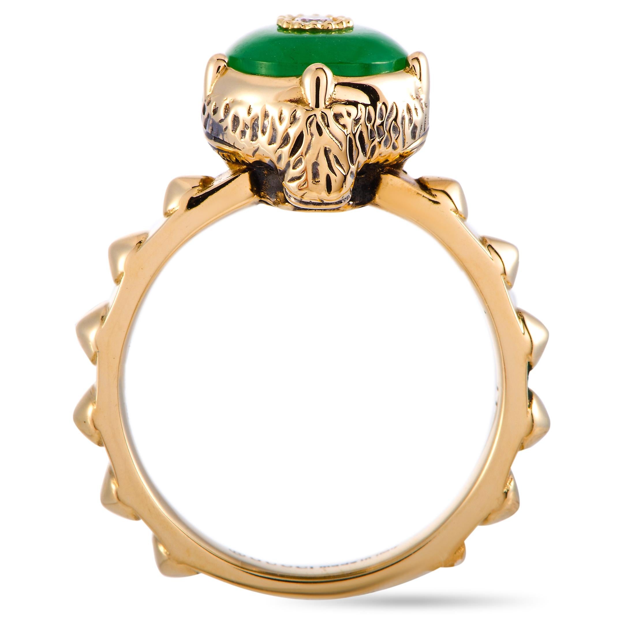 The “LMDM” ring by Gucci is crafted from 18K yellow gold and set with three diamond stones and a jade. The jade weighs approximately 1.45 carats and the diamonds feature GH color and VVS clarity and total approximately 0.05 carats. The ring weighs