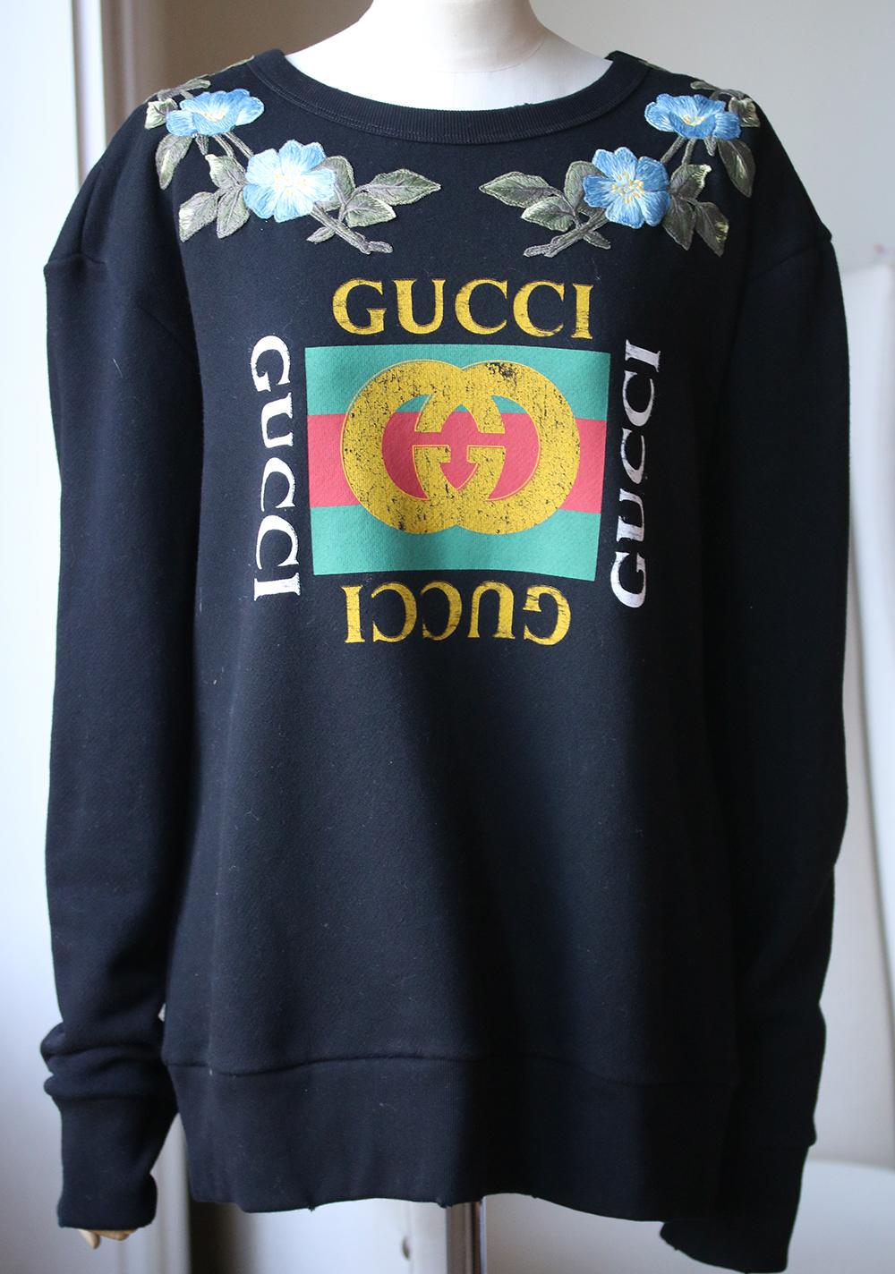 This black and multi-coloured Gucci cotton 'Loved' GG floral sweatshirt has us punch drunk for its flawless Italian craftsmanship and multi-coloured 'Gucci Print' logo print at the front. This jumper has been crafted from cotton and features a crew