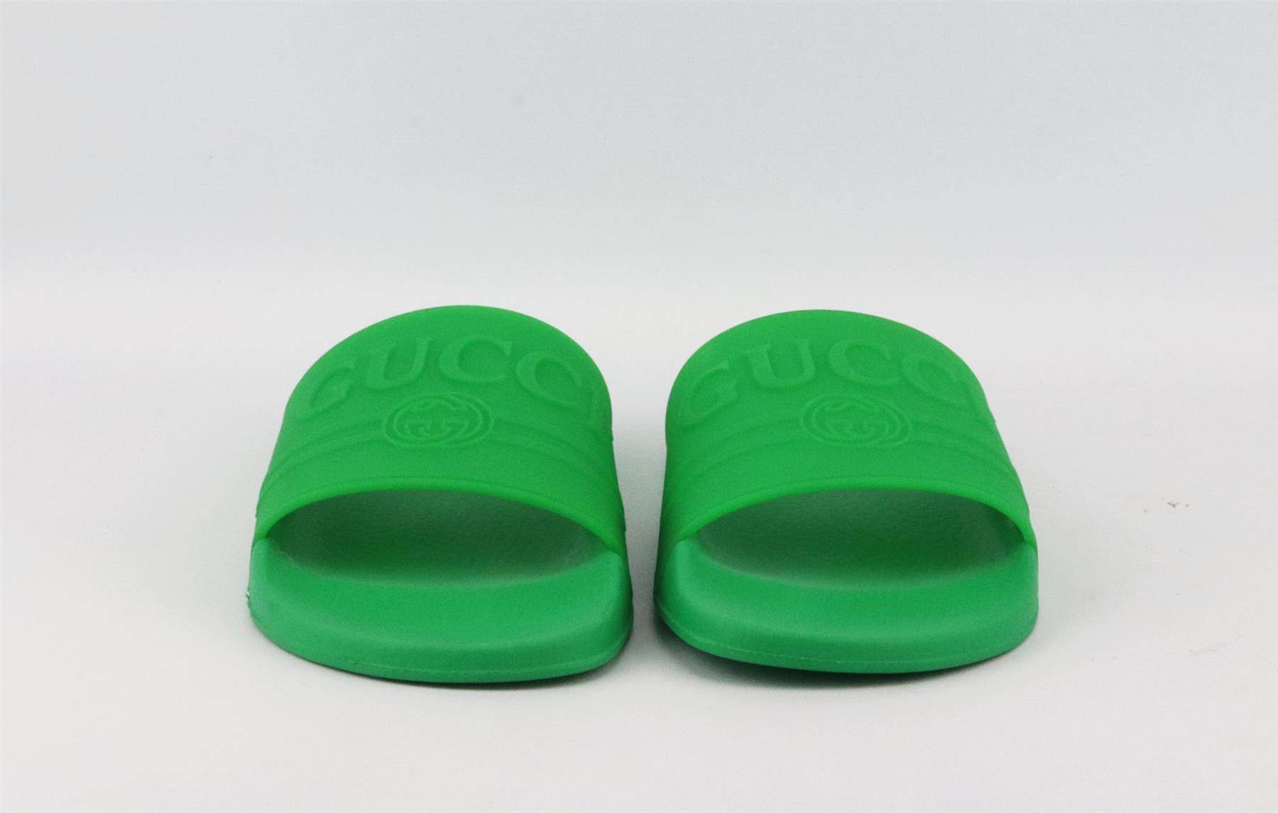These slides by Gucci are made in Italy from rubber, they have a comfy molded leather insole and are embossed with the house's logo in raised lettering on the top. Sole measures approximately 20mm/ 1 inch. Green rubber. Slips on. Does not come with