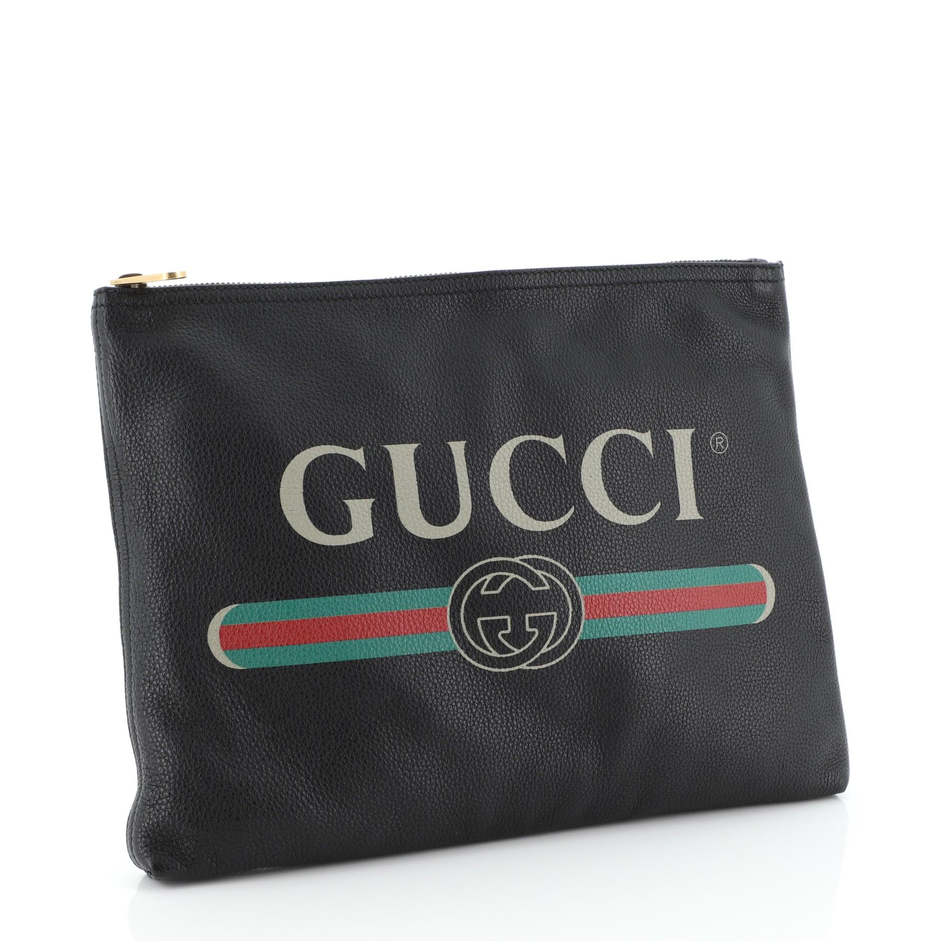 This Gucci Logo Portfolio Clutch Printed Leather Medium, crafted from pink and black leather, features printed Gucci logo and aged gold-tone hardware. Its zip closure opens to a black suede interior. 

Estimated Retail Price: $950
Condition: Great.