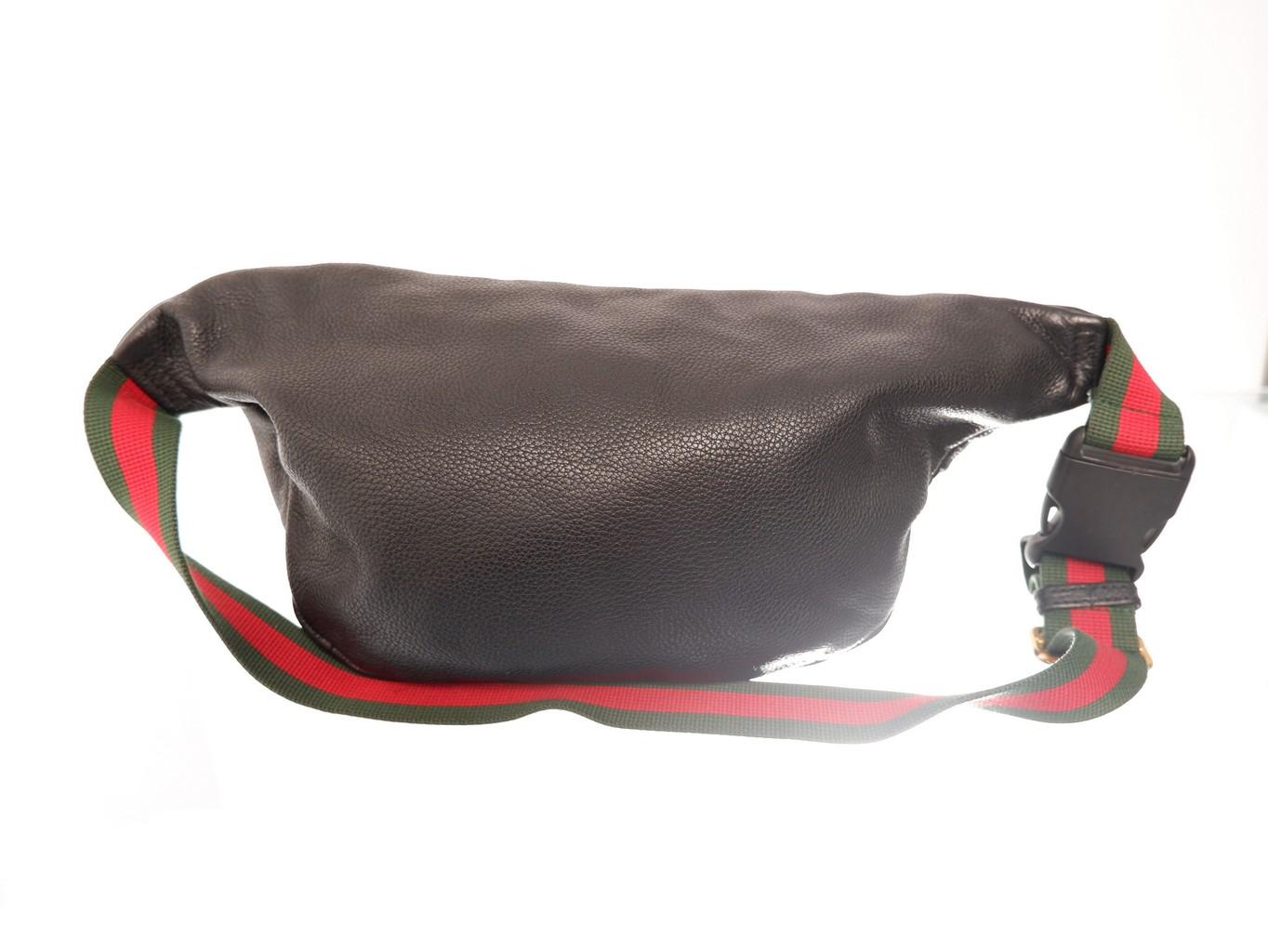 Black leather Gucci print belt bag features vintage logo print, a zip top closure, adjustable web stripe waist belt strap that can also be worn across the chest, fine textile lining interior with gold-tone hardware.

 

110182MSC