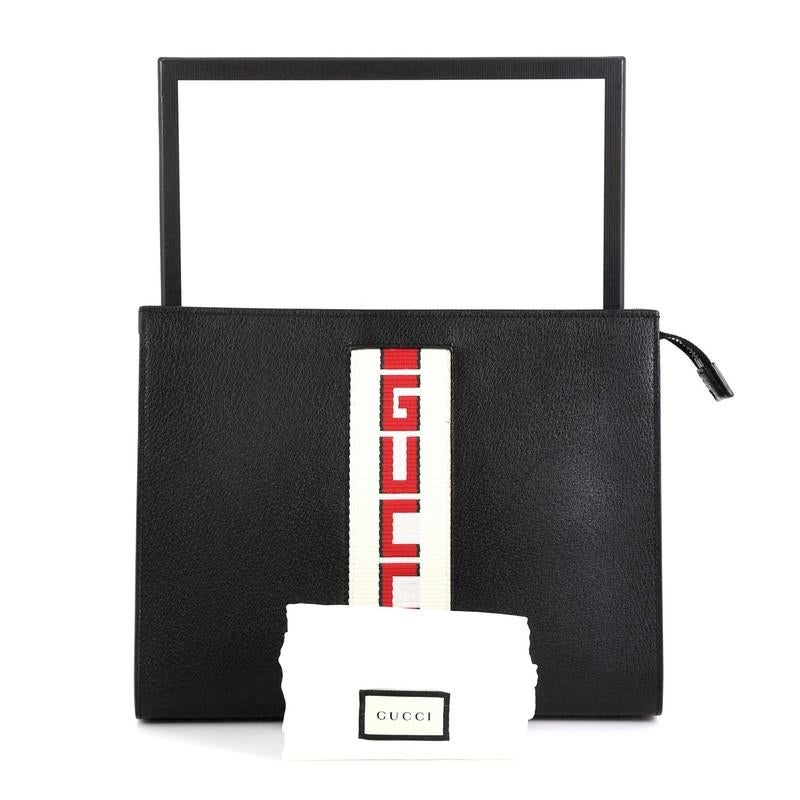 This Gucci Logo Stripe Pouch Leather, crafted from black leather, features silver-tone hardware. Its zip closure opens to a gray microfiber interior. 

Estimated Retail Price: $795
Condition: Great. Minor discoloration, glue stains and small marks