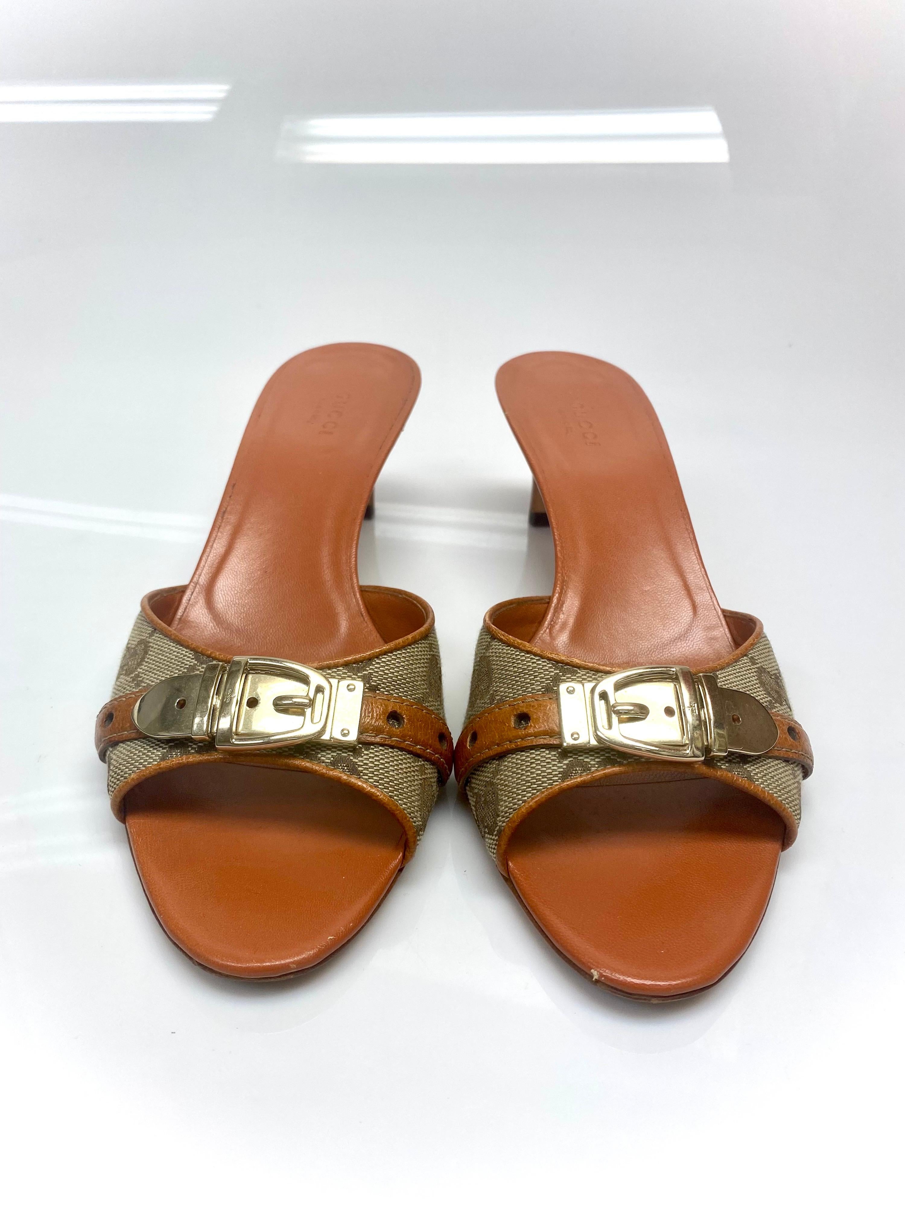 These gorgeous leather Gucci logo kitten heels/mules' will be a perfect shoe to add to any luxury collection. The shoe features a silver centered buckle and Gucci monogram through the design which is highlighted by the brown leather. Item is in very