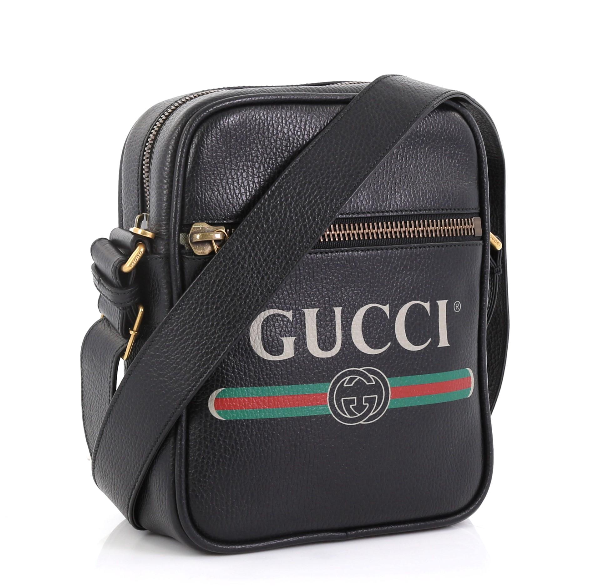 This Gucci Logo Zip Messenger Bag Printed Leather Small, crafted from black printed leather, features adjustable leather strap, front zip pocket, printed Gucci vintage logo, and aged gold-tone hardware. Its top zip closure opens to a beige canvas
