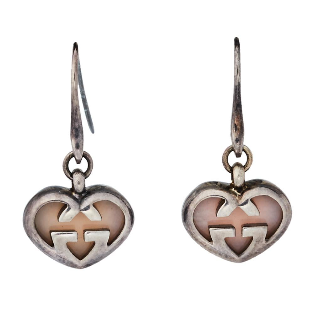 Perfectly designed for a statement look, these drop earrings from Gucci flaunt the iconic GG motif in a refreshing style. The pair features pink stone inlays and a silver body. These beauties are not only elegant but are bold enough to punctuate