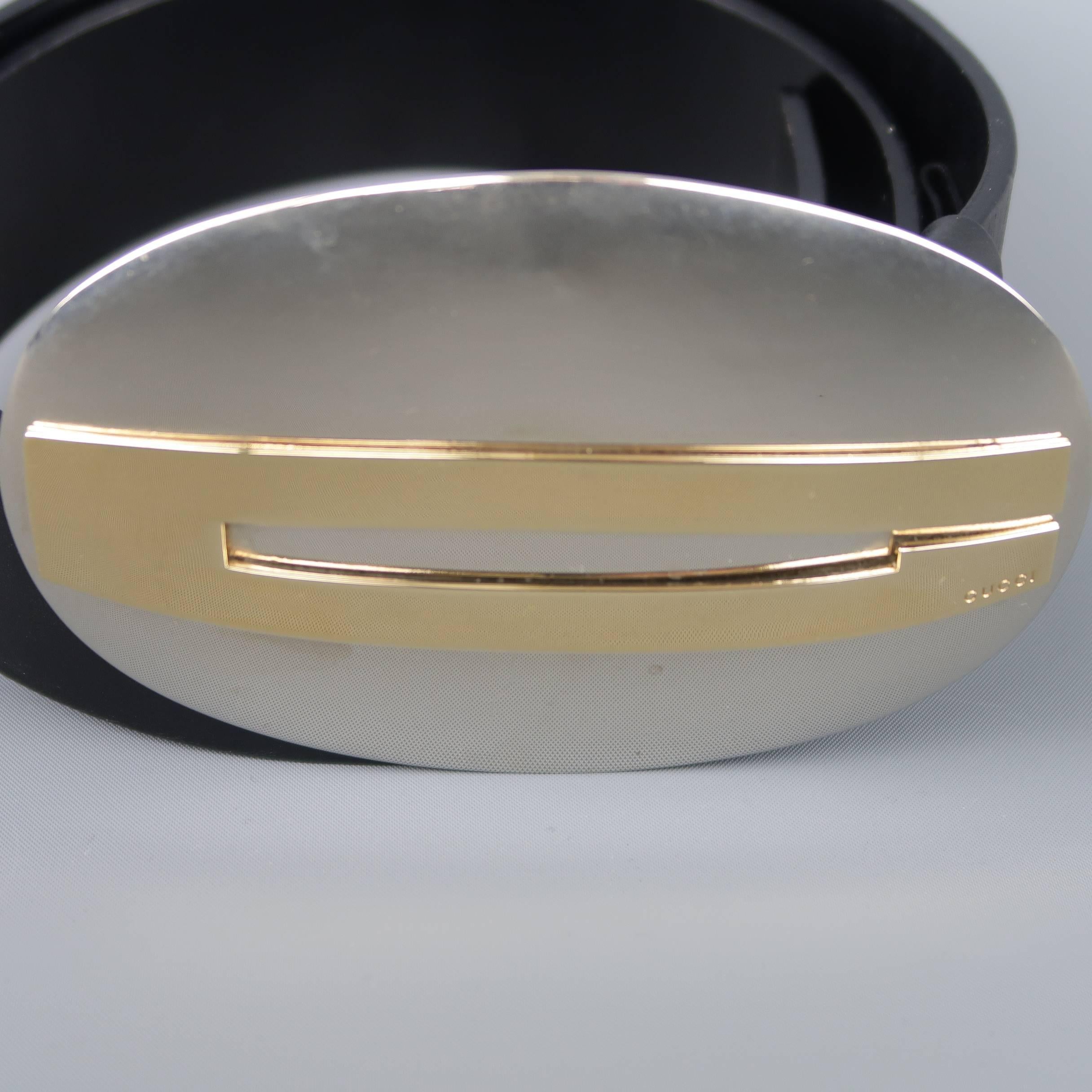 Archive GUCCI belt features an oversized polished silver tone metal buckle with gold tone G on a black leather strap. Minor aging on buckle. As-is. Made in Italy.
 
Good Pre-Owned Condition.
Marked: 85.34
 
Measurements:
 
Length: 36.5 in.
Width: